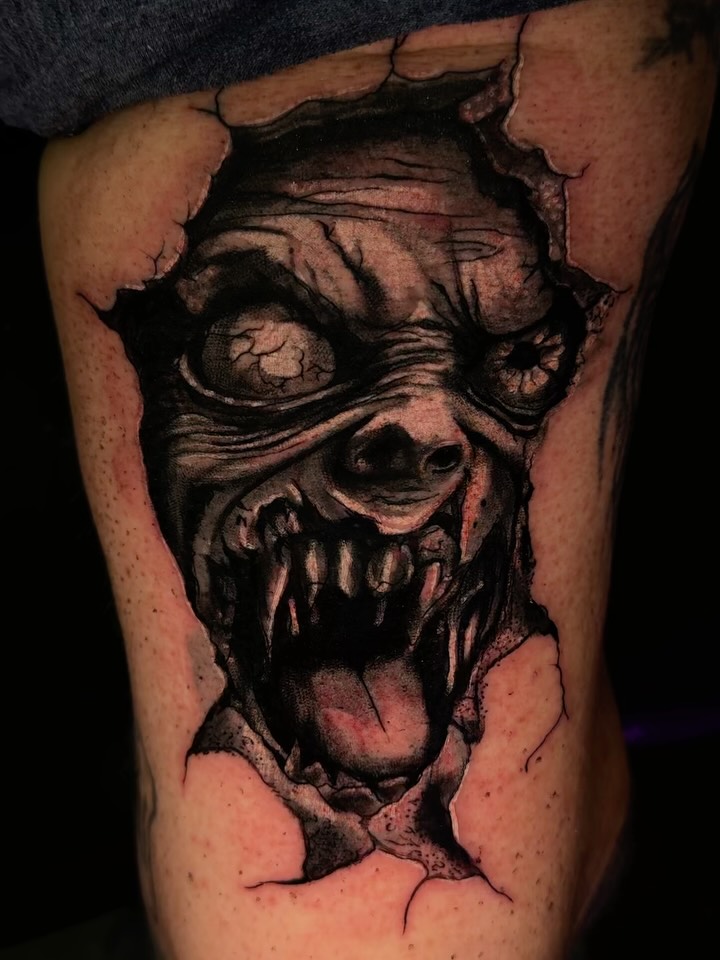 Zombie face dark realism tattoo on the thigh by Therapy ink
