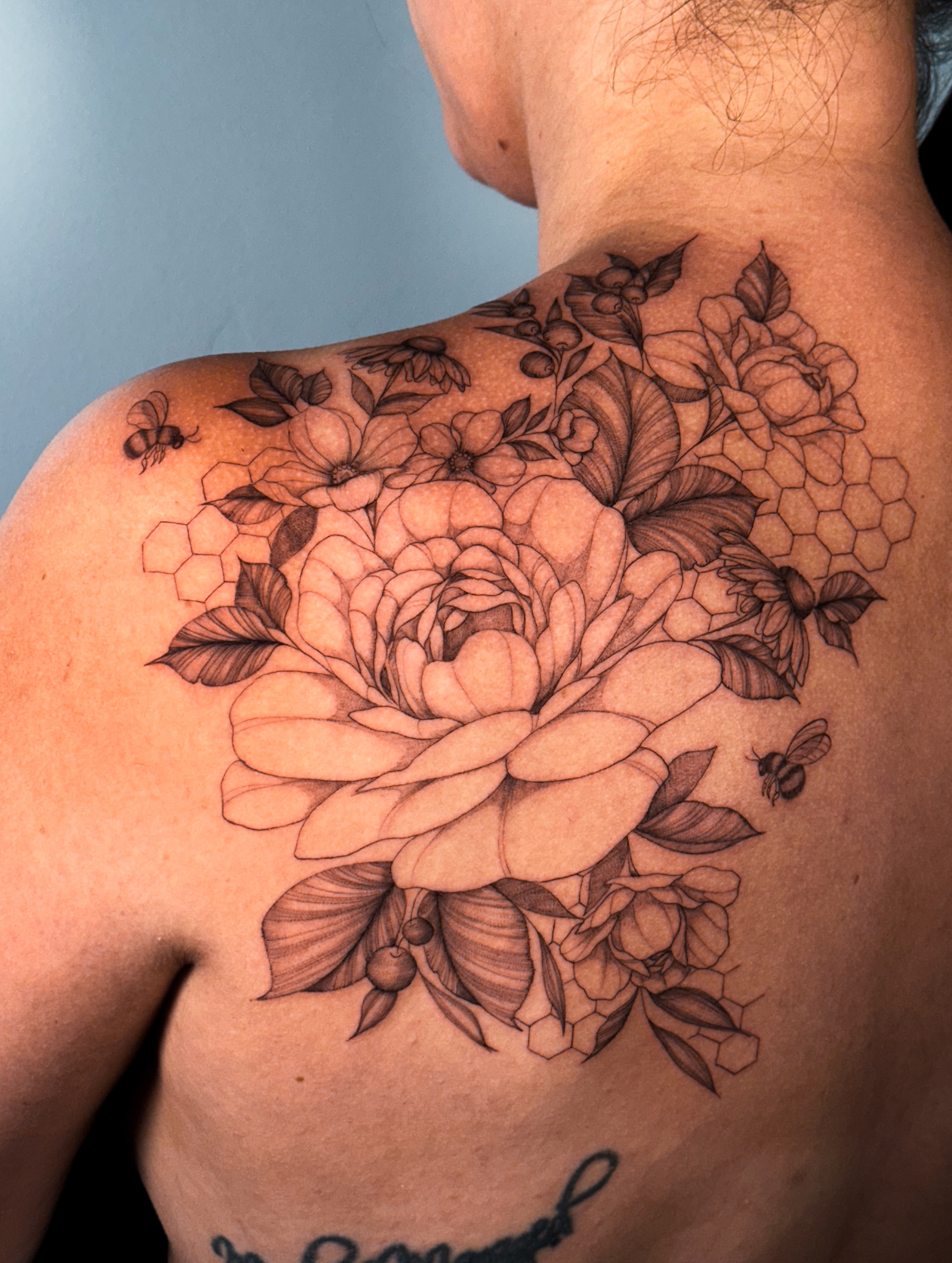 Peony flower black and grey tattoo on the back by Caroline + Utah Tattoo Artist