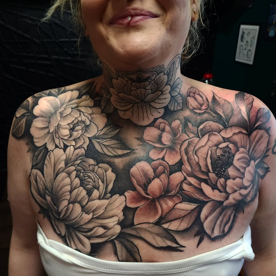 Floral chest and neck tattoo dotwork tattoo on the chest by Chris Wodarski