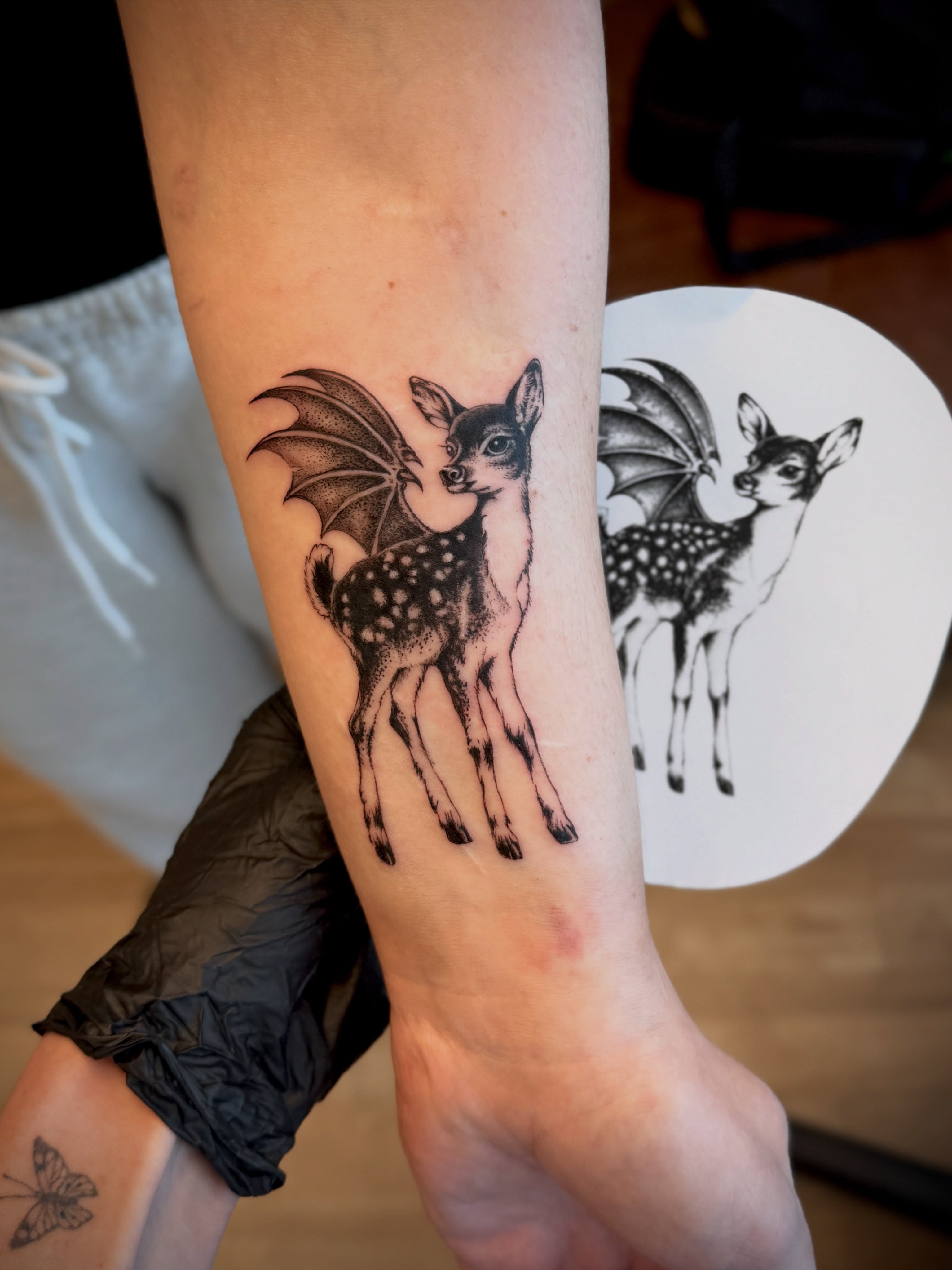 Deer with bat wings dotwork tattoo on the forearm by Aristova Anastasia