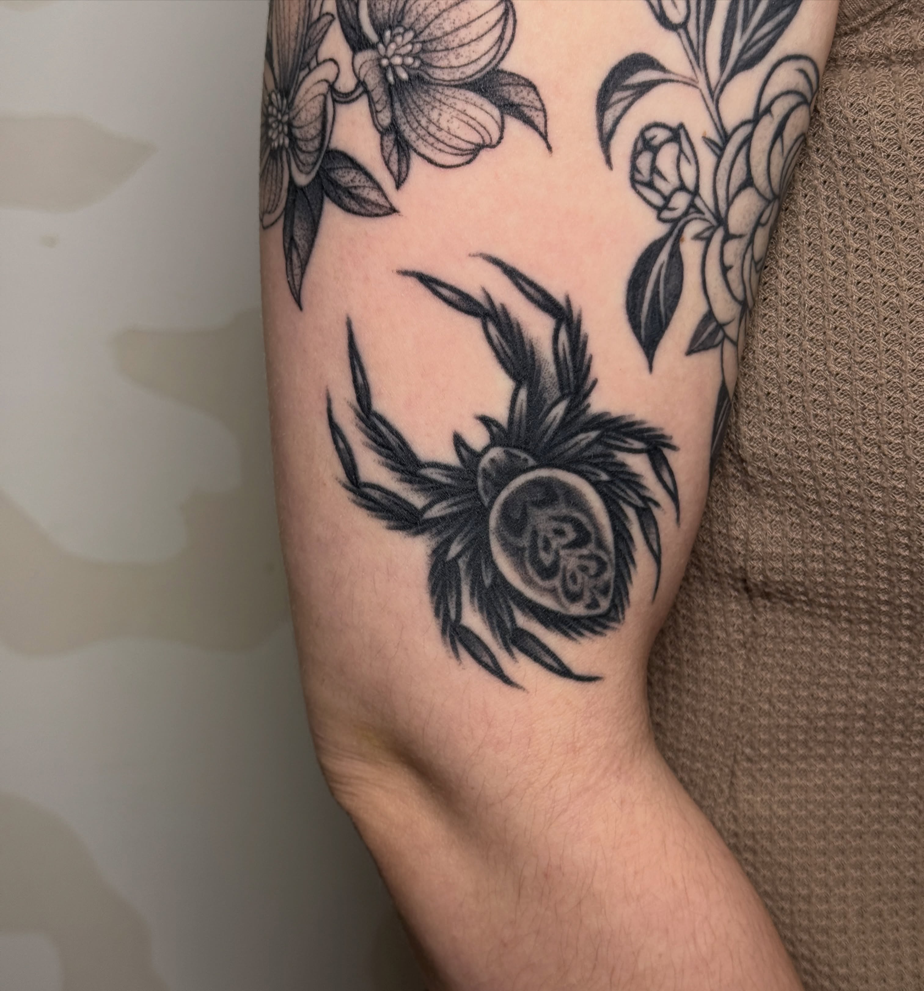Flower and thistle black and grey tattoo on the forearm by Bre Grover, Vancouver, British Columbia