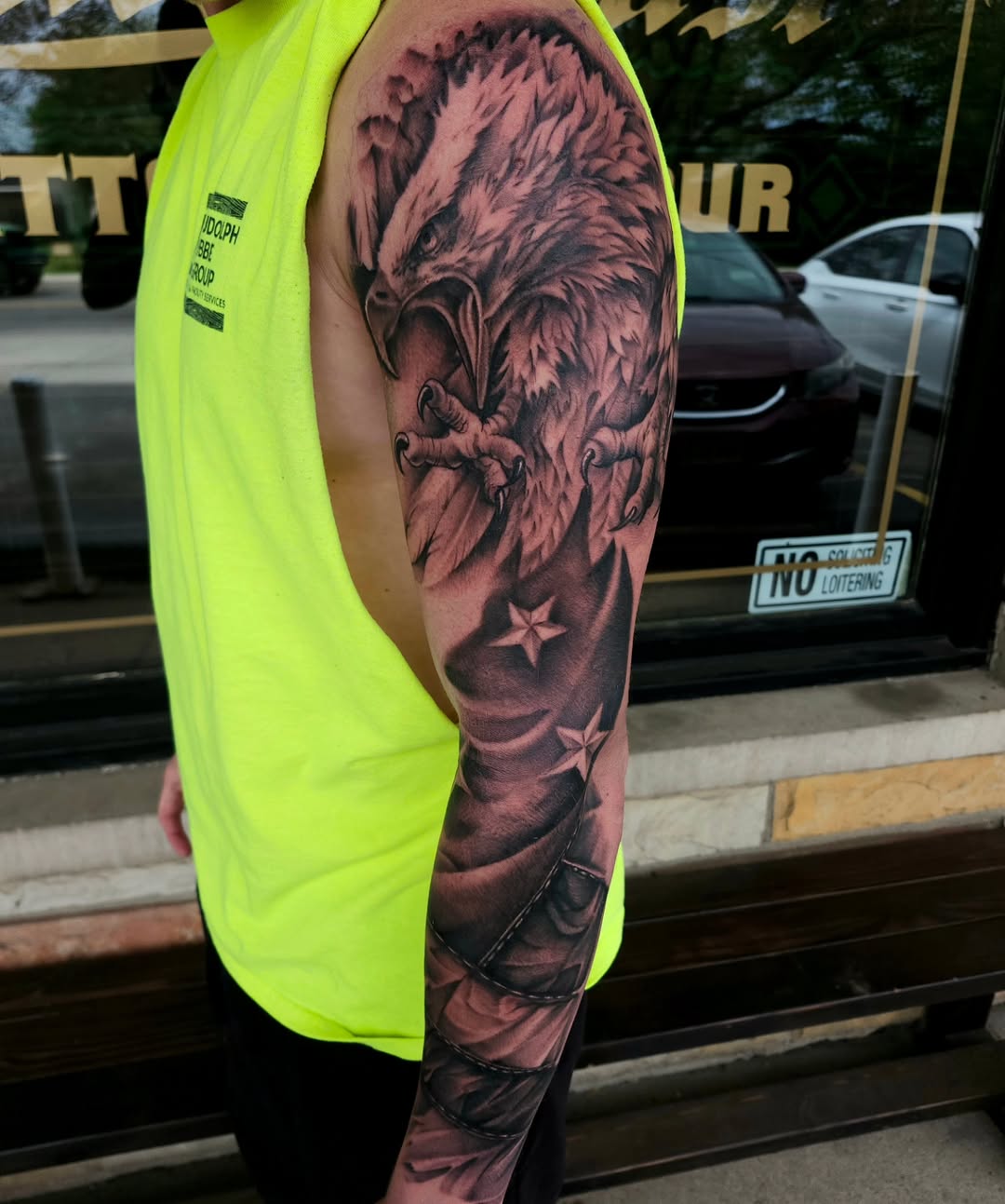 Eagle and american flag tattoo on the upper arm by Chris Wodarski
