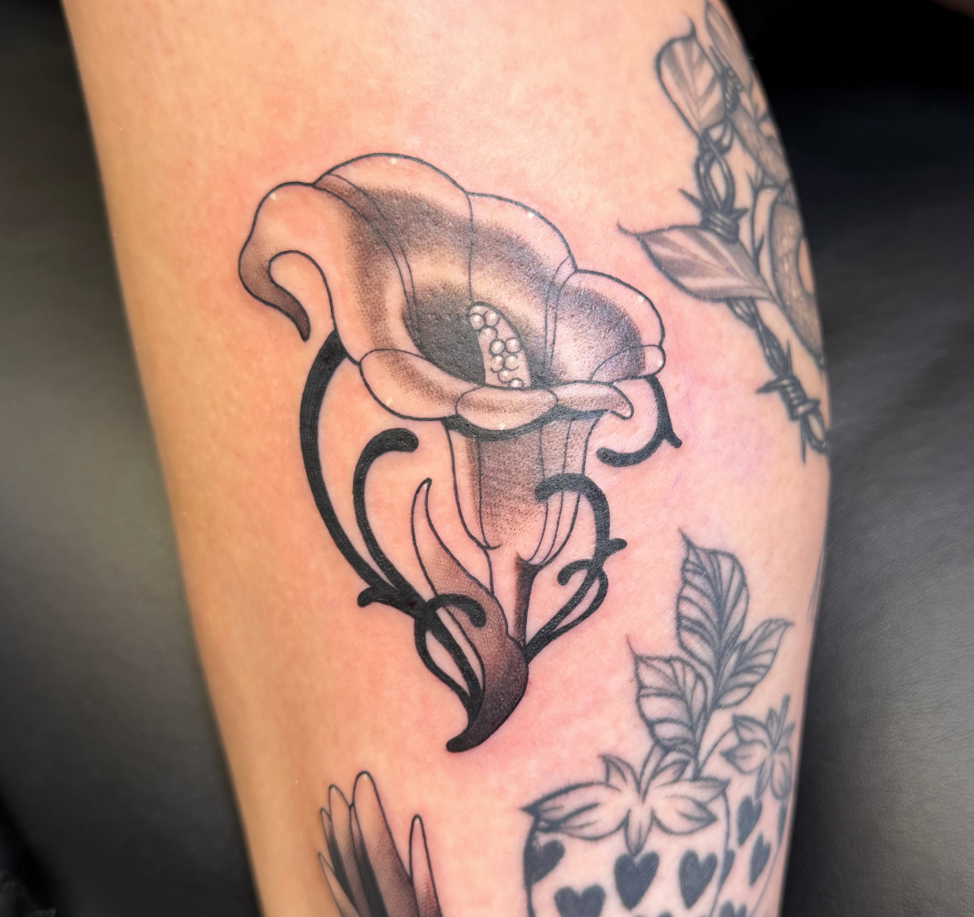 Calla lily black and grey tattoo on the forearm by zoey sage ✦