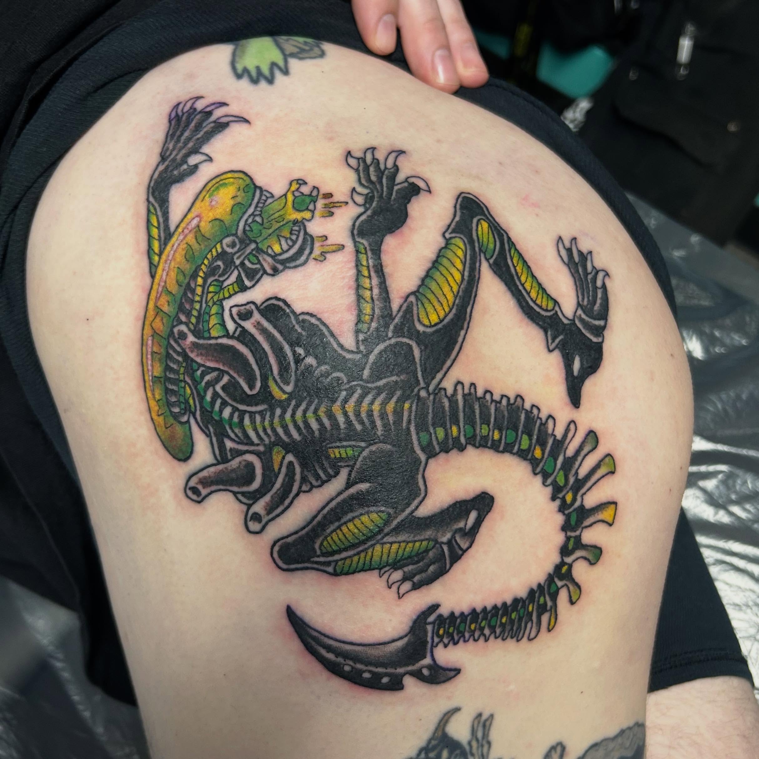 Alien vs. lizard American traditional tattoo on the thigh by Randy Bray