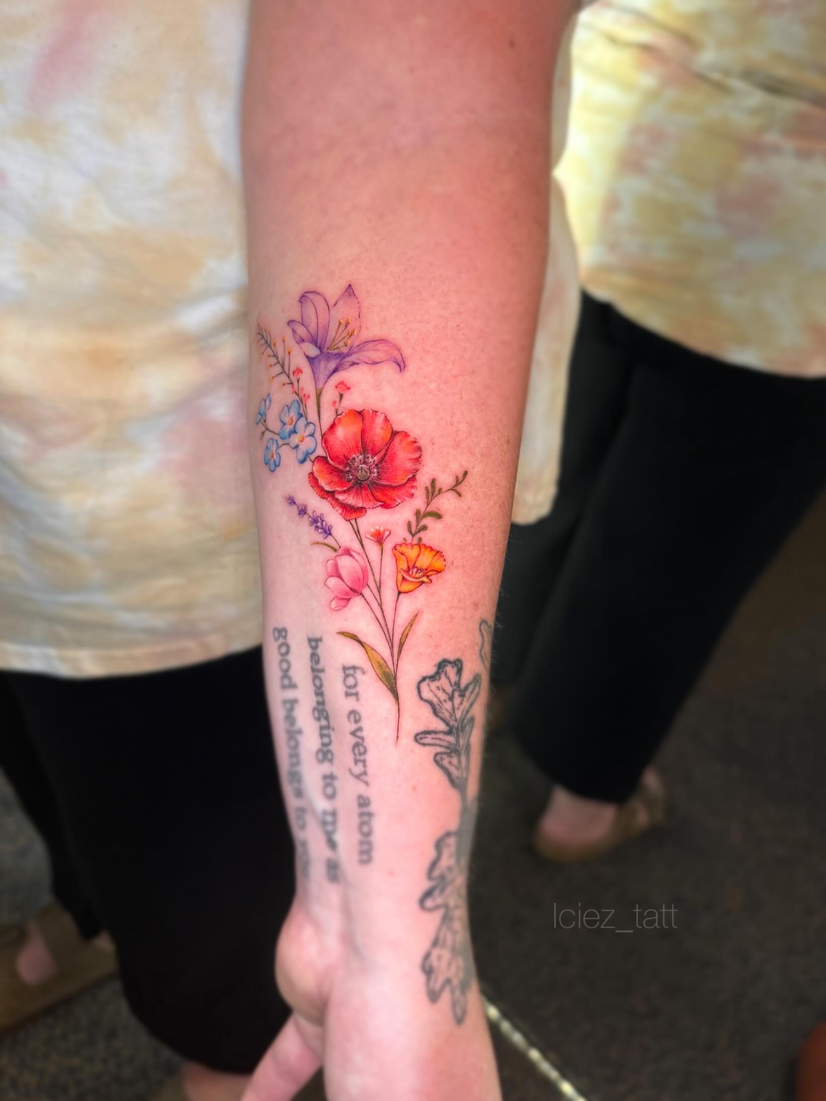 Floral arrangement watercolor tattoo on the forearm by Iciez