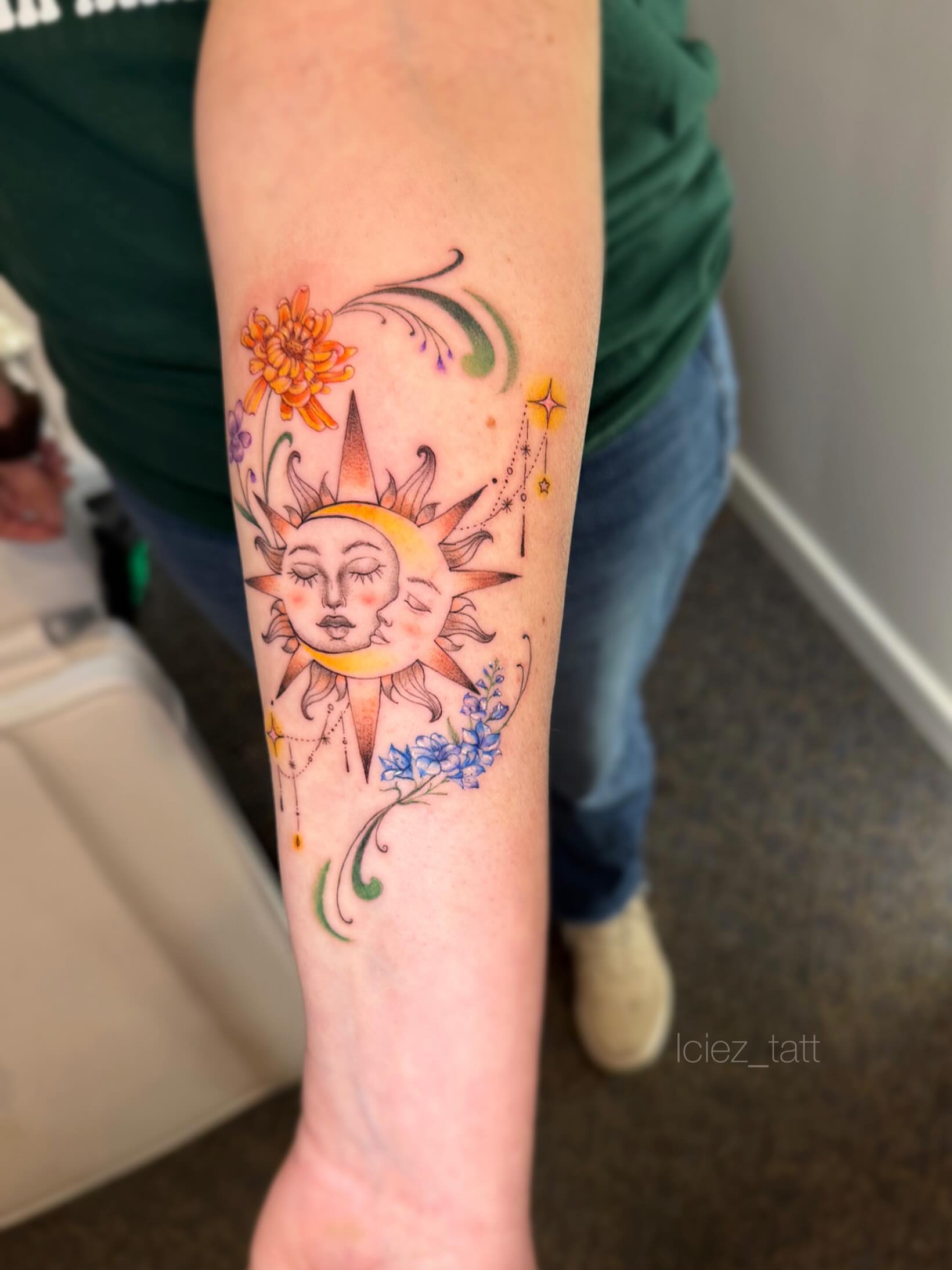 Sun and moon faces watercolor tattoo on the forearm by Iciez