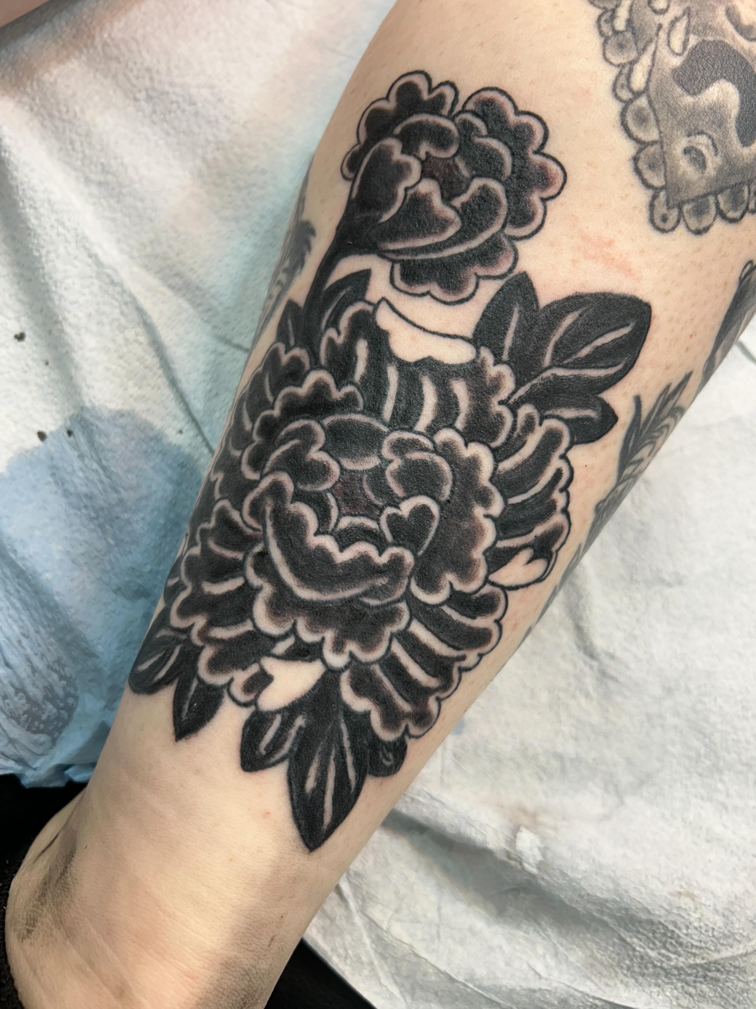 Peony flowers black and grey tattoo on the forearm by Stogie Tony