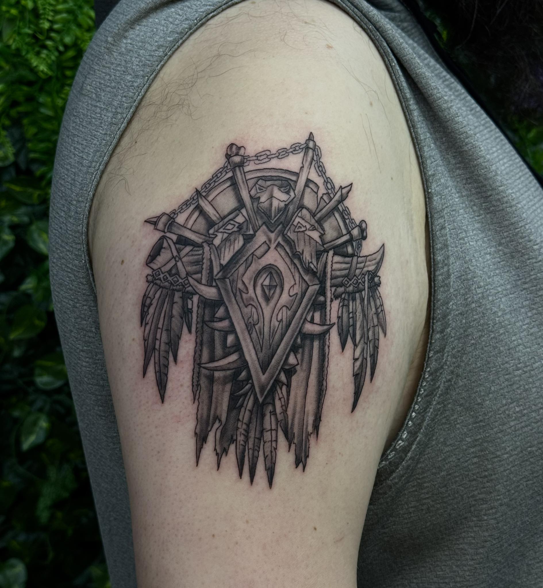Viking shield black and grey tattoo on the shoulder by Sabrina