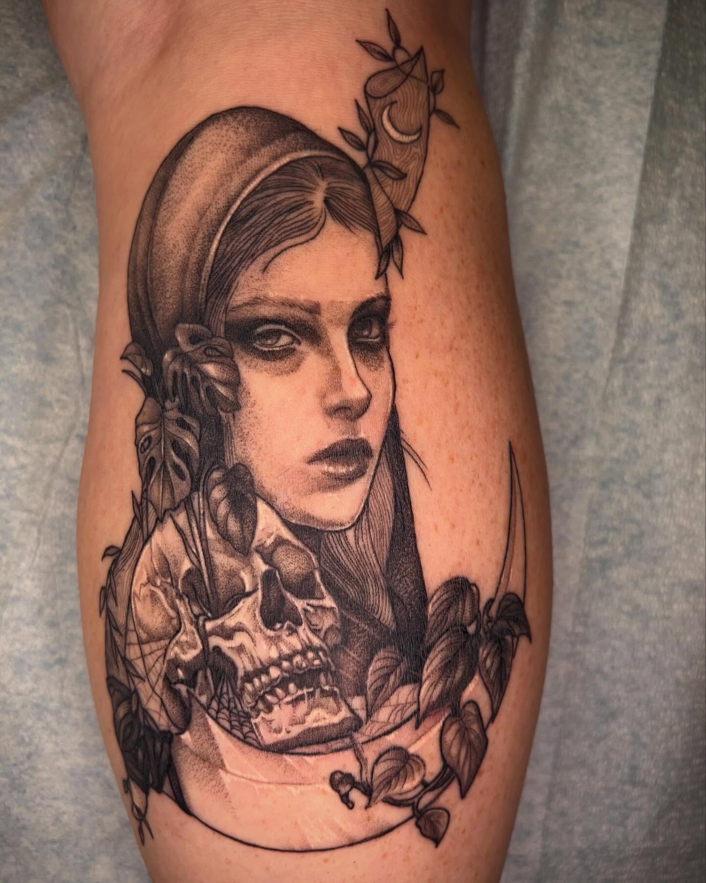 Woman with skull realism tattoo on the thigh by Emily Falkowski