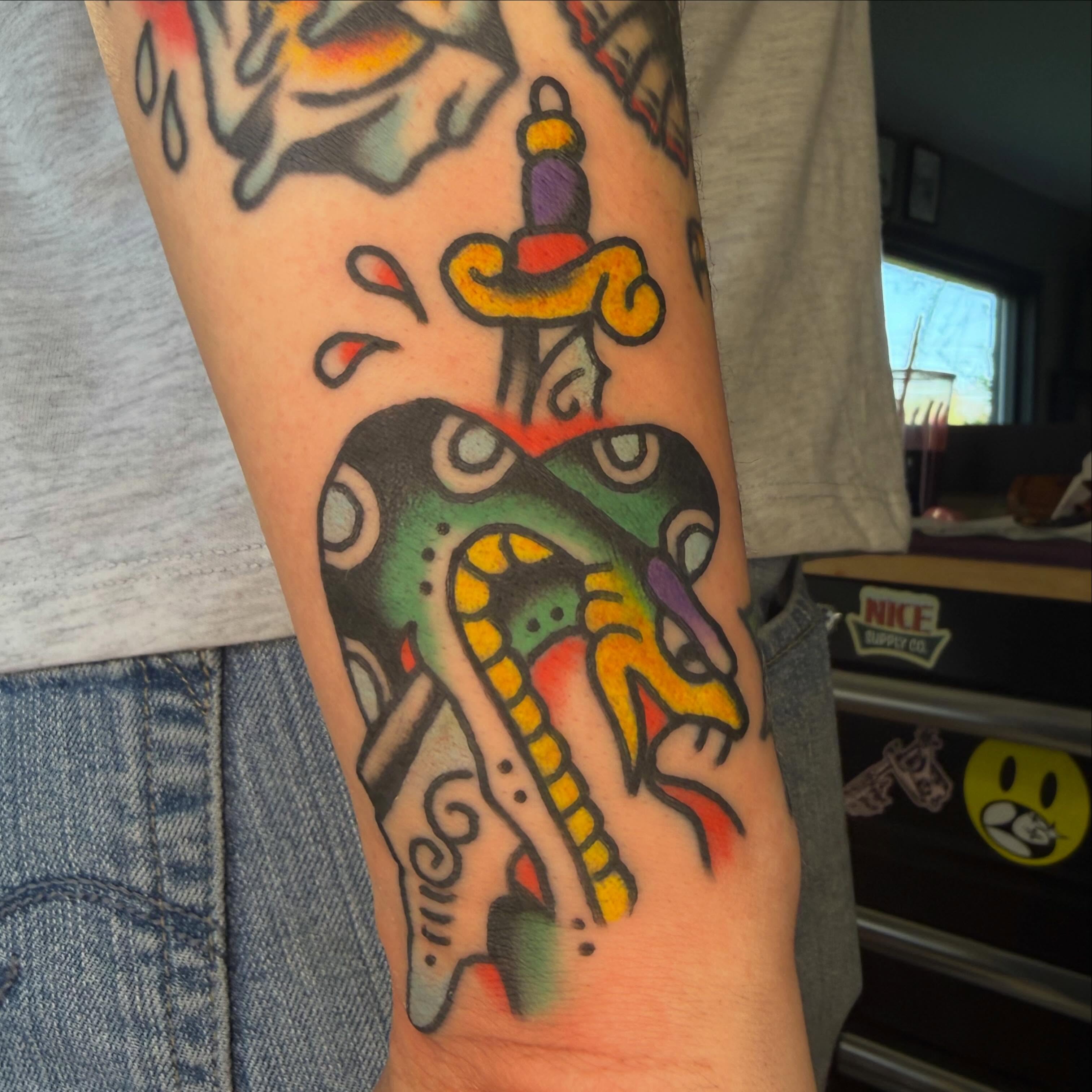 Heart with snake American traditional tattoo on the forearm by Tyler