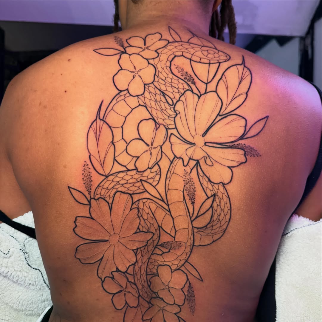 Snake and flowers black and grey tattoo on the back by Andreanna Rosemarie Gabranidis, Pennsauken, New Jersey