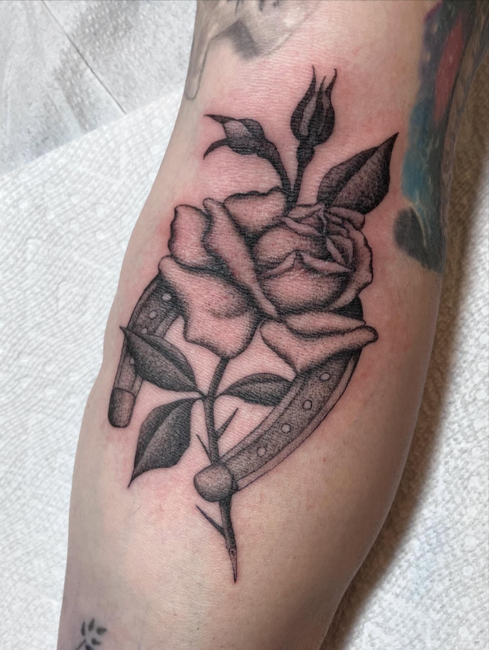 Rose black and grey tattoo on the forearm by Jackson Kirchhoff