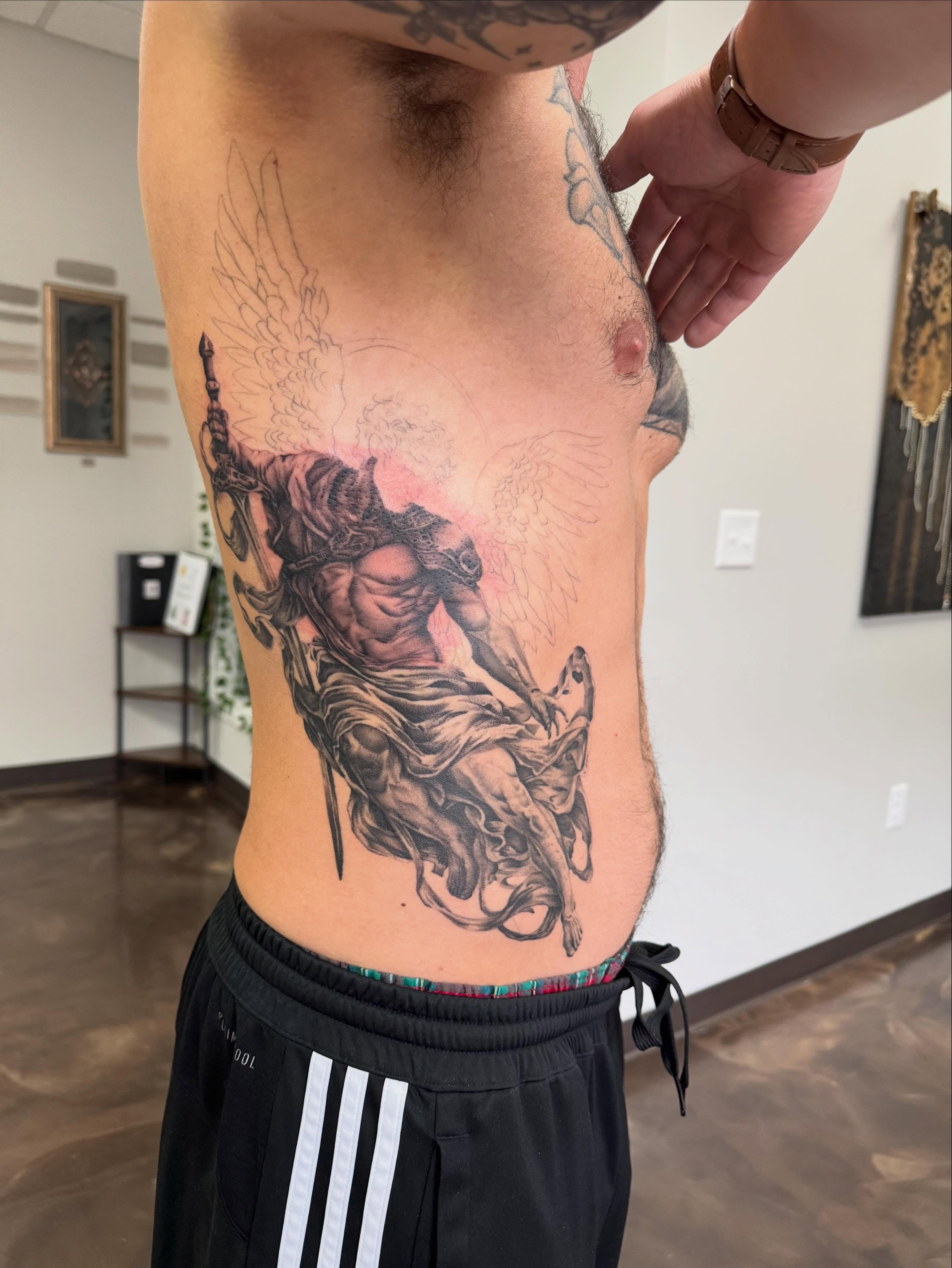 Warrior on horseback realism tattoo on the ribs by Jon Fleming