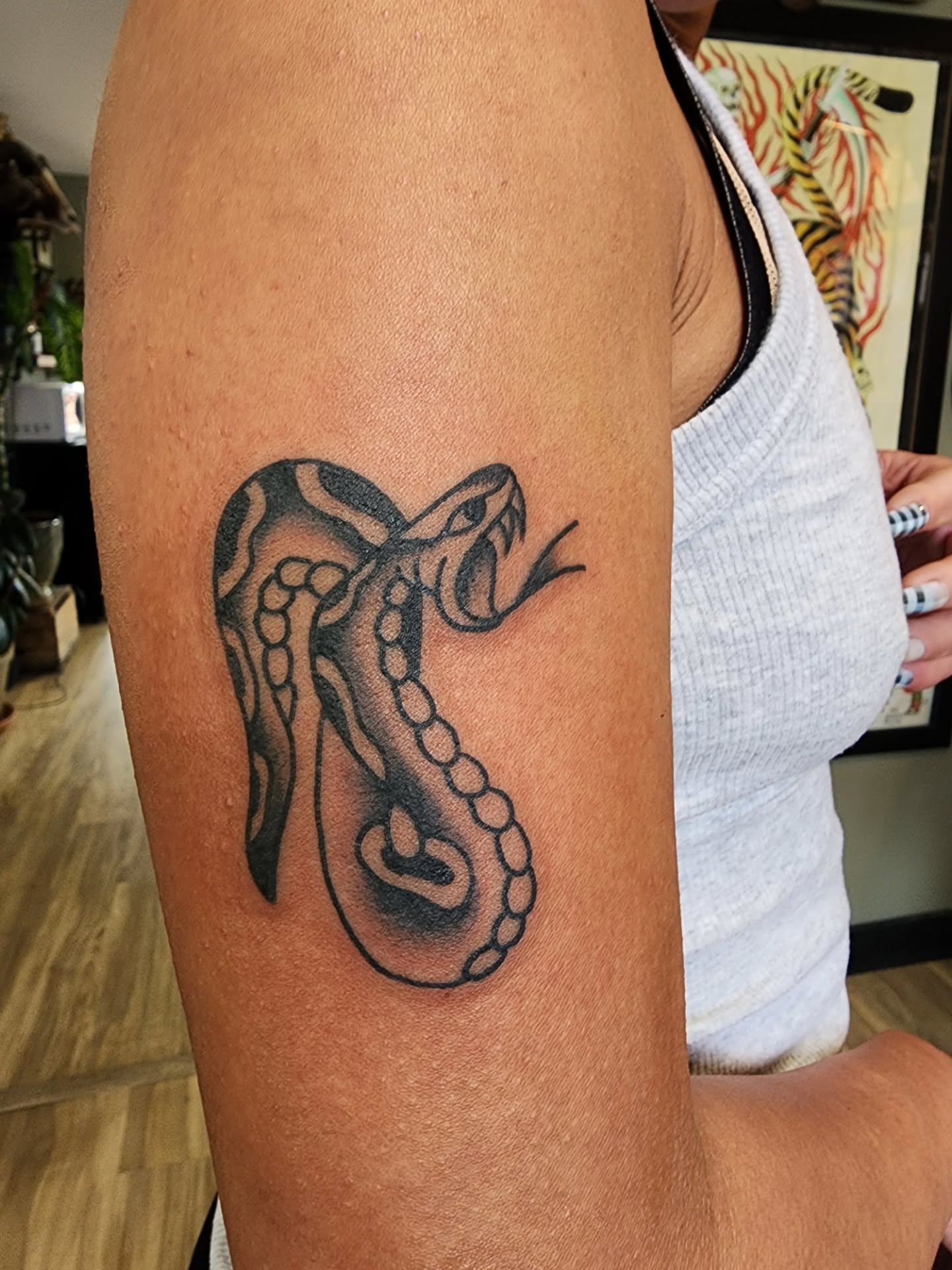 Snake black and grey tattoo on the forearm by πππππ