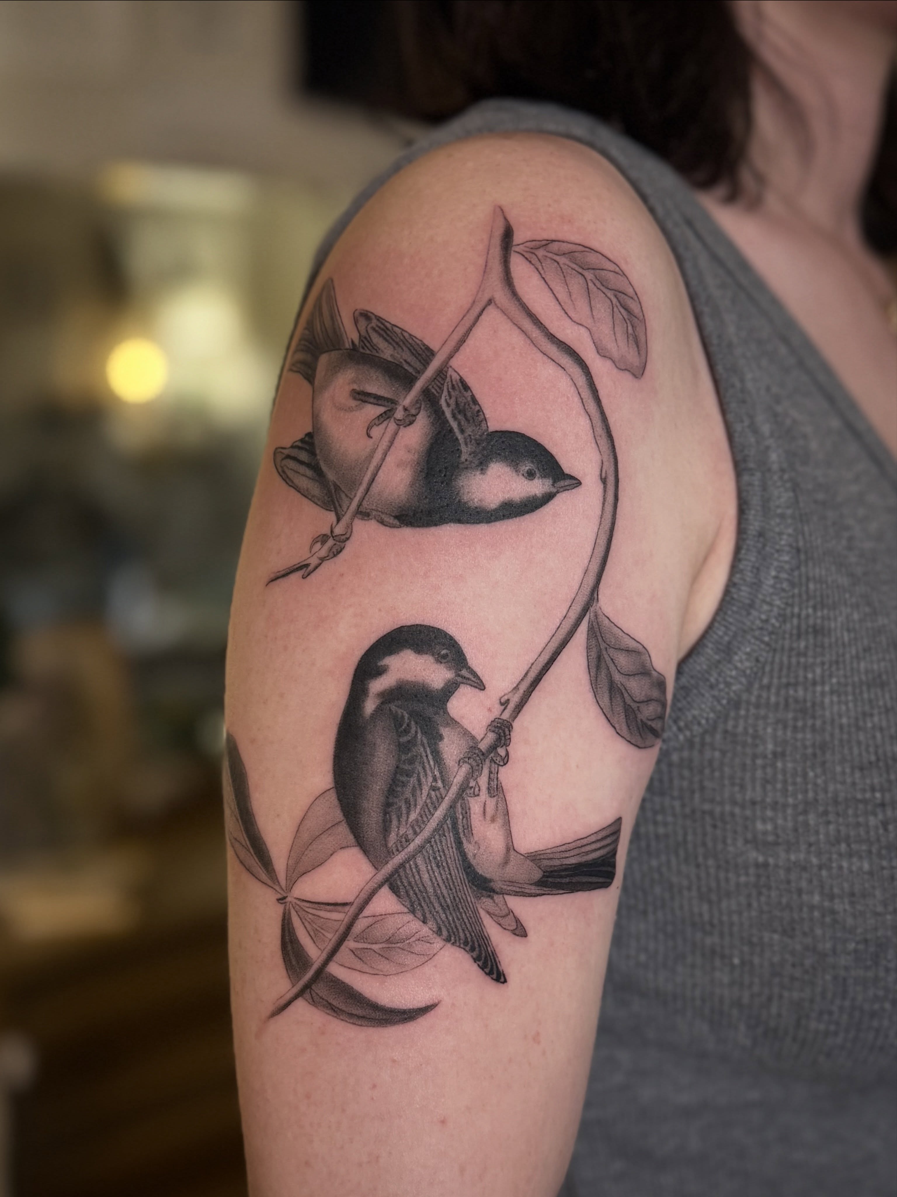 Birds realism tattoo on the upper arm by Leah - Tattoo Artist