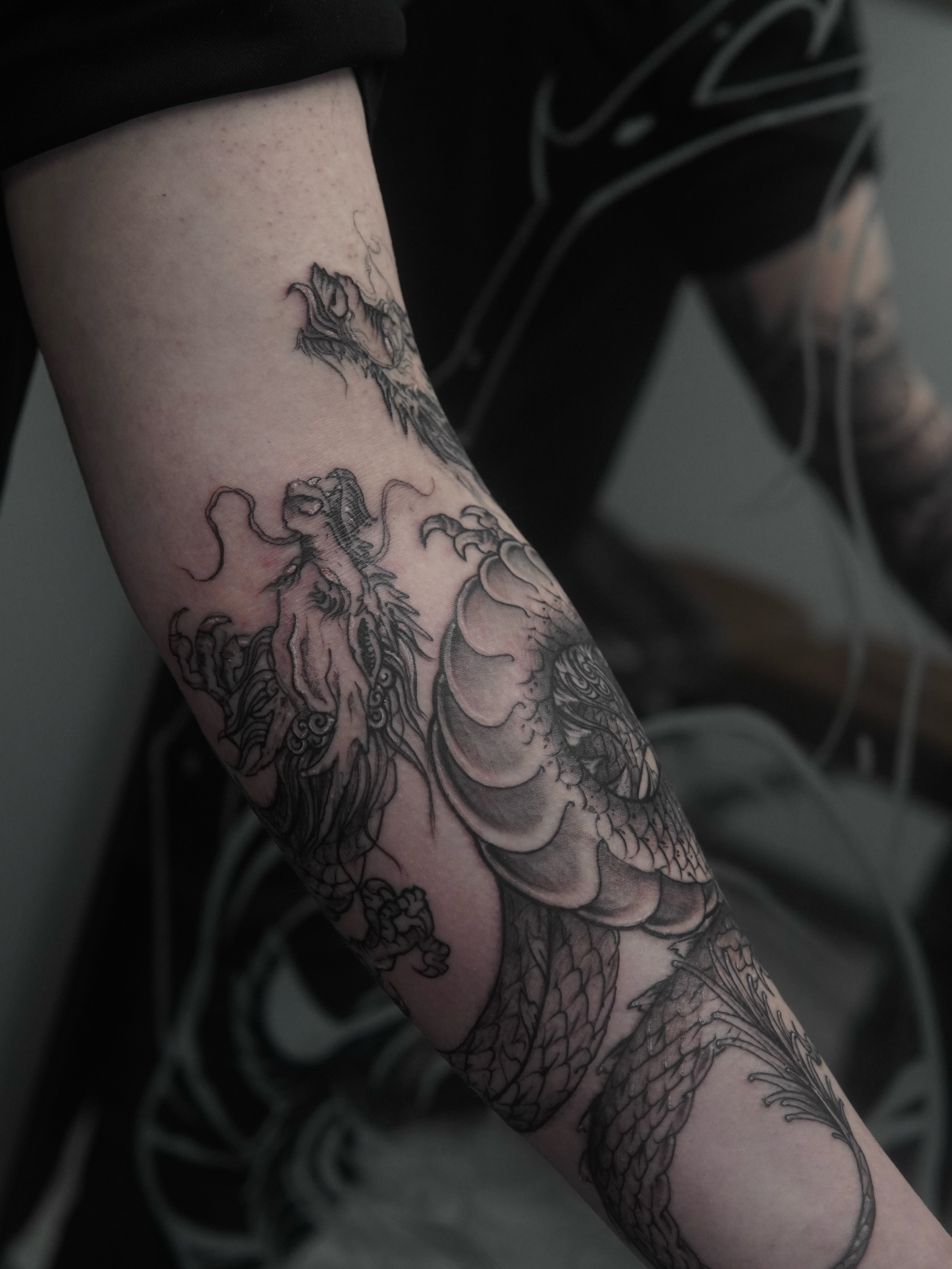 Dragon black and grey tattoo on the forearm by Sebastian