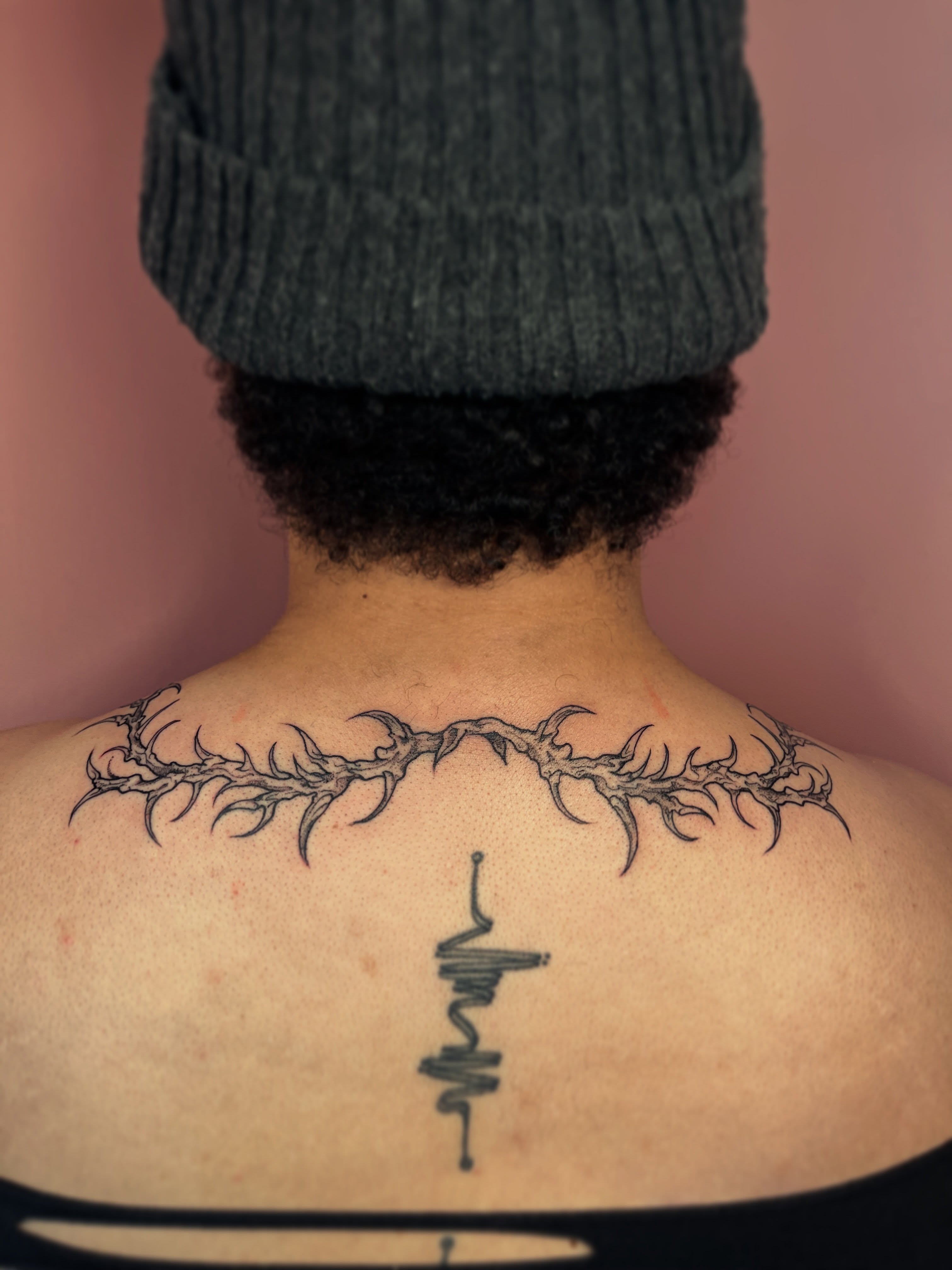 Spine tattoo black and grey tattoo on the back by Allyson Blessing Tattoos