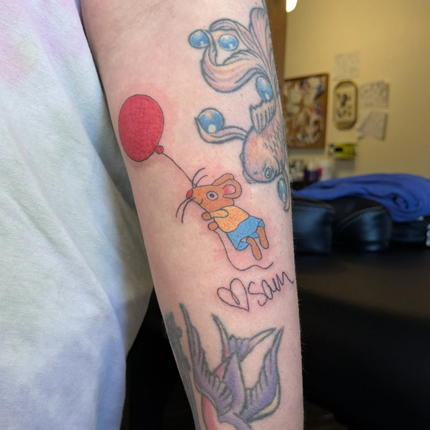 Mouse with balloon illustrative tattoo on the forearm by Madison Cañedo ✺ Portland tattoo