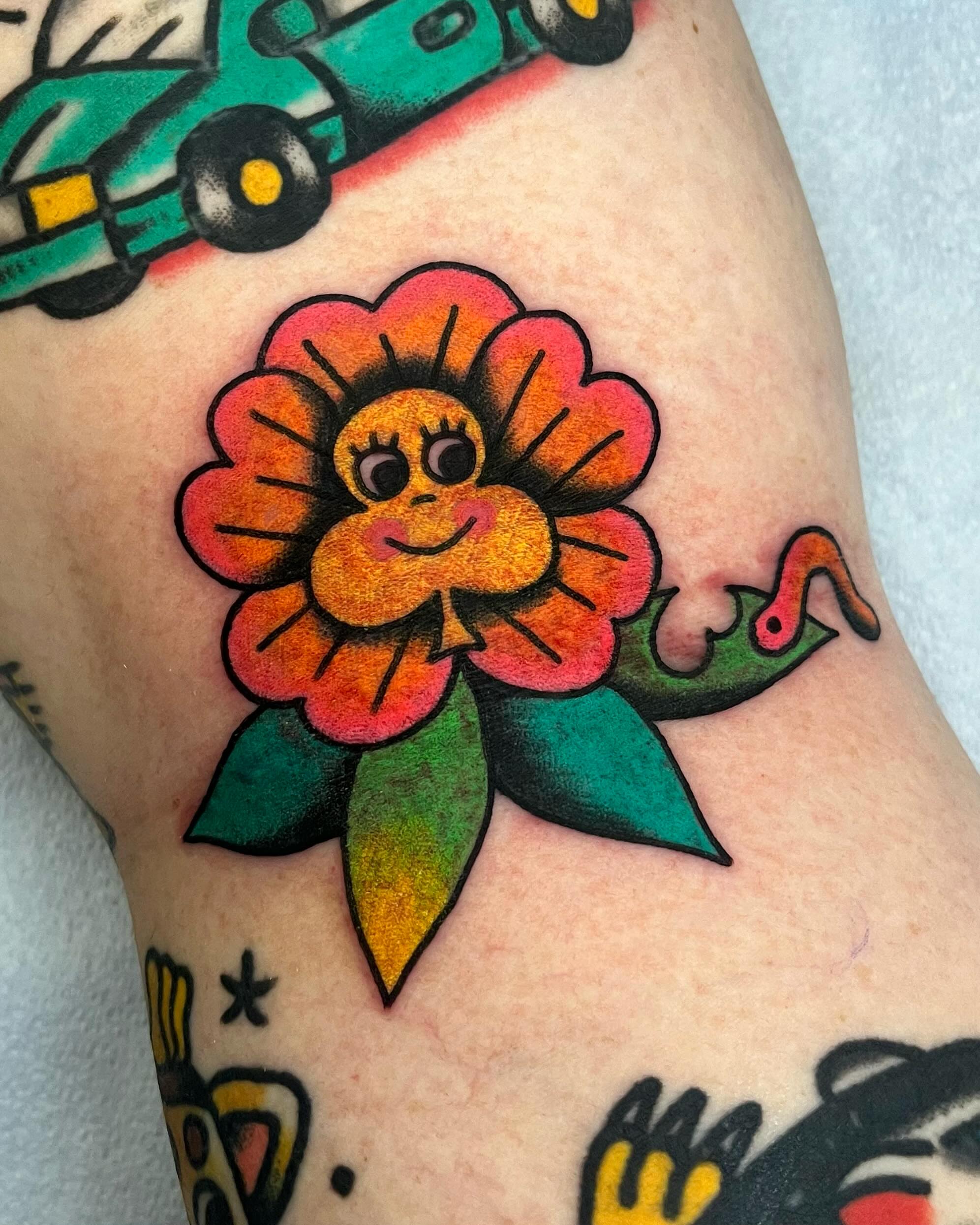 Flower American traditional tattoo on the forearm by Em Adkins