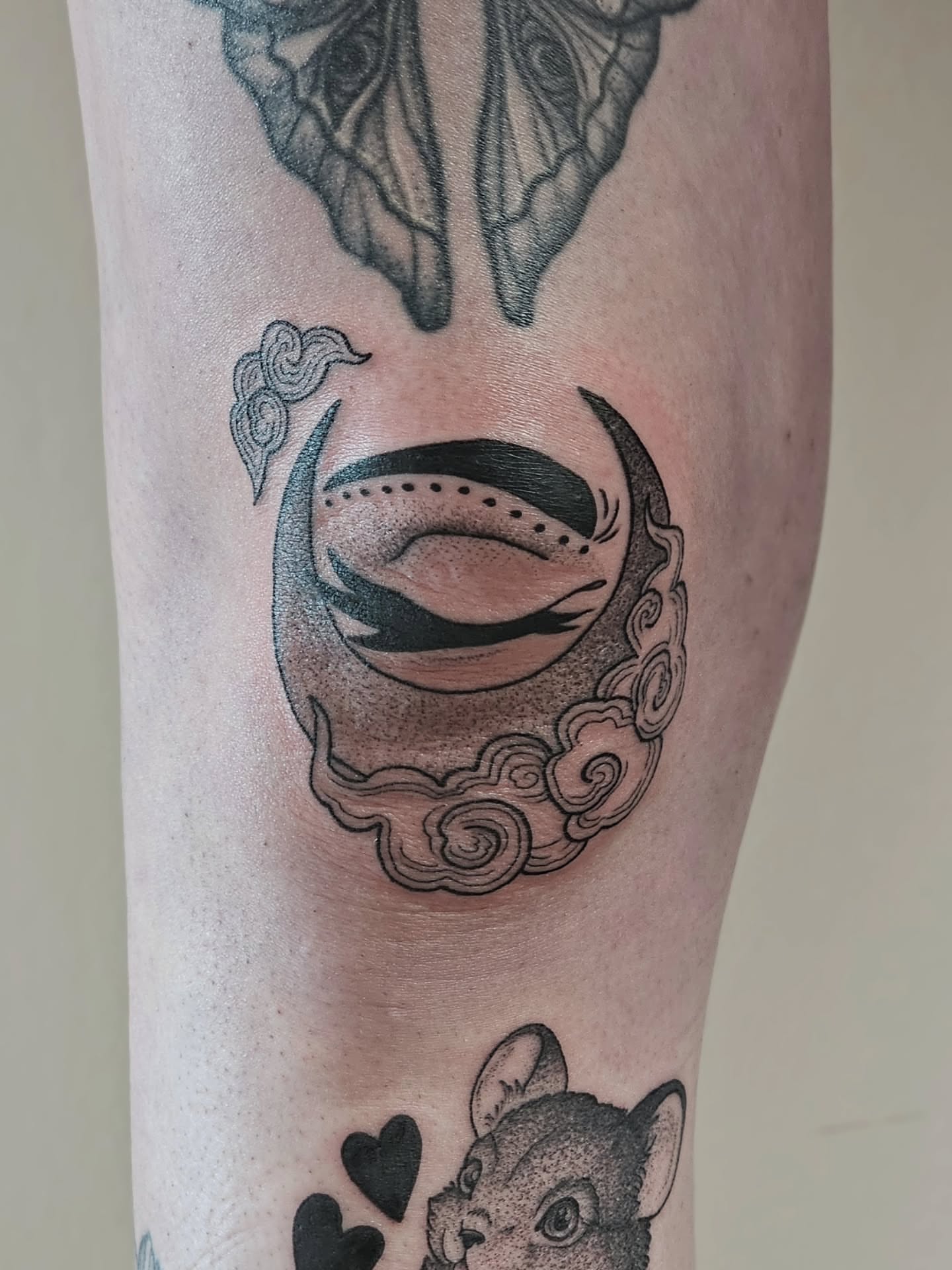 Moon and clouds dotwork tattoo on the forearm by Kylie Lund