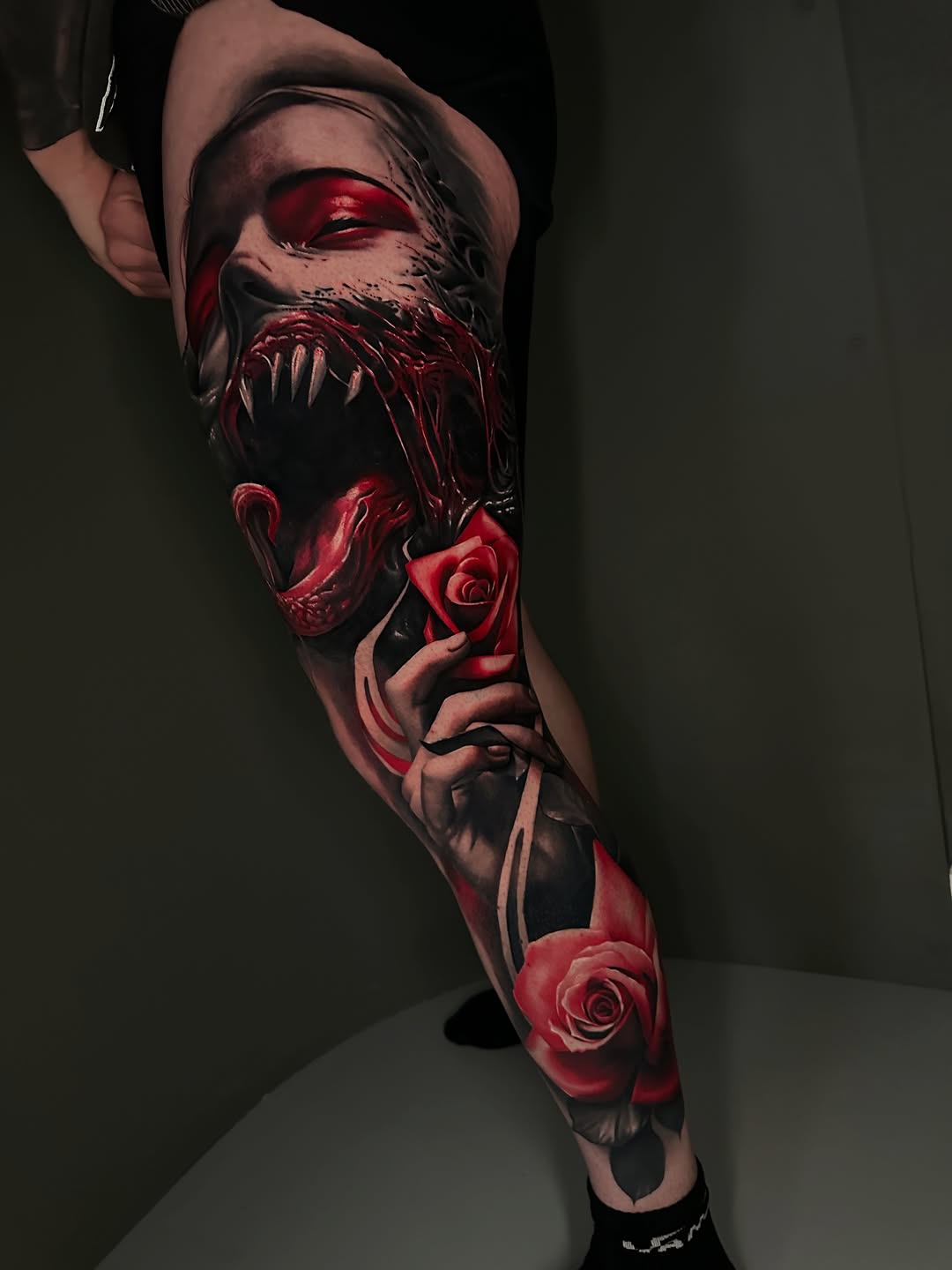Demonic face with roses realism tattoo on the forearm by Dakota Case