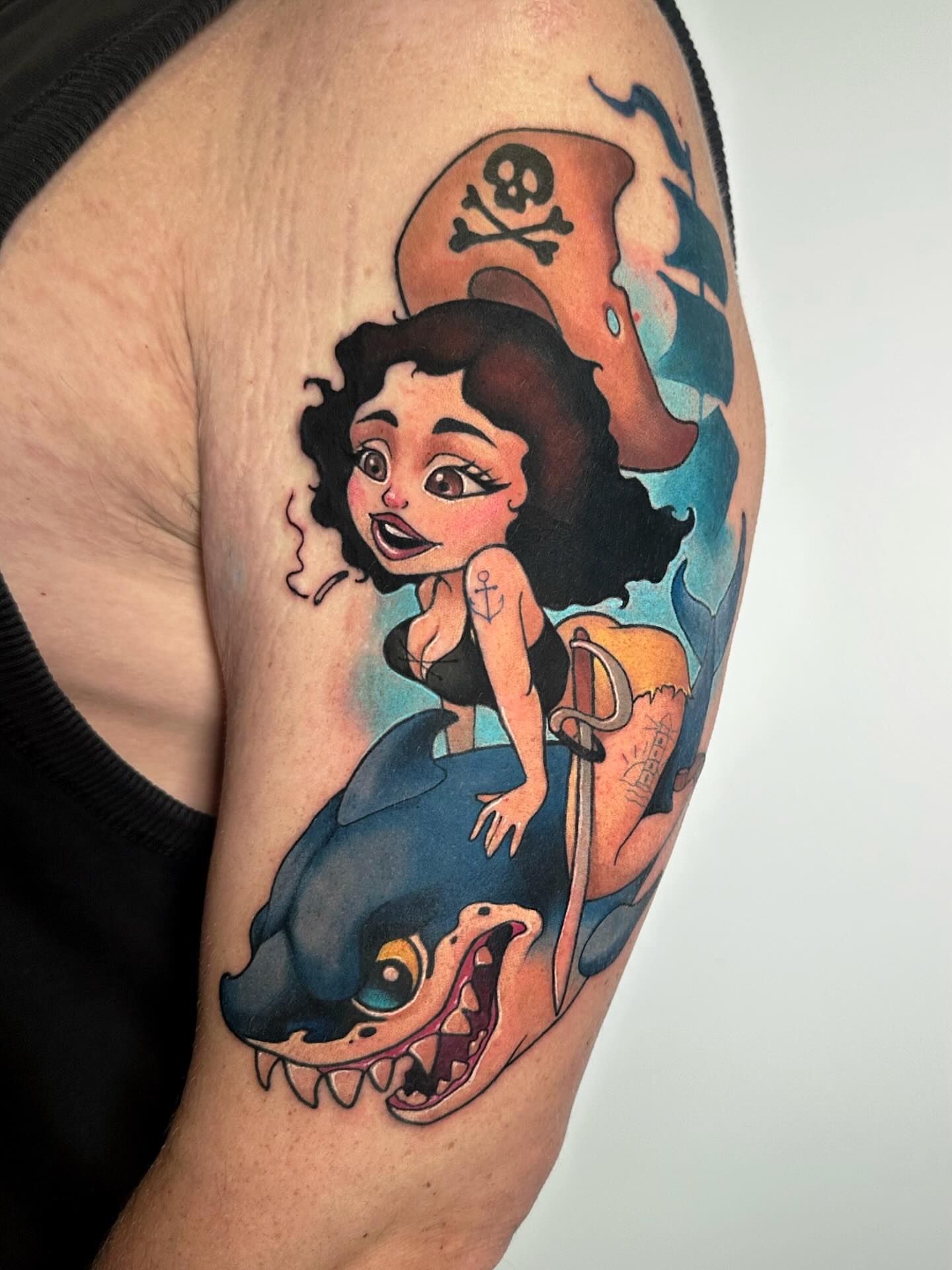 Pirate girl riding shark American traditional tattoo on the upper arm by Lena Aleksandrova