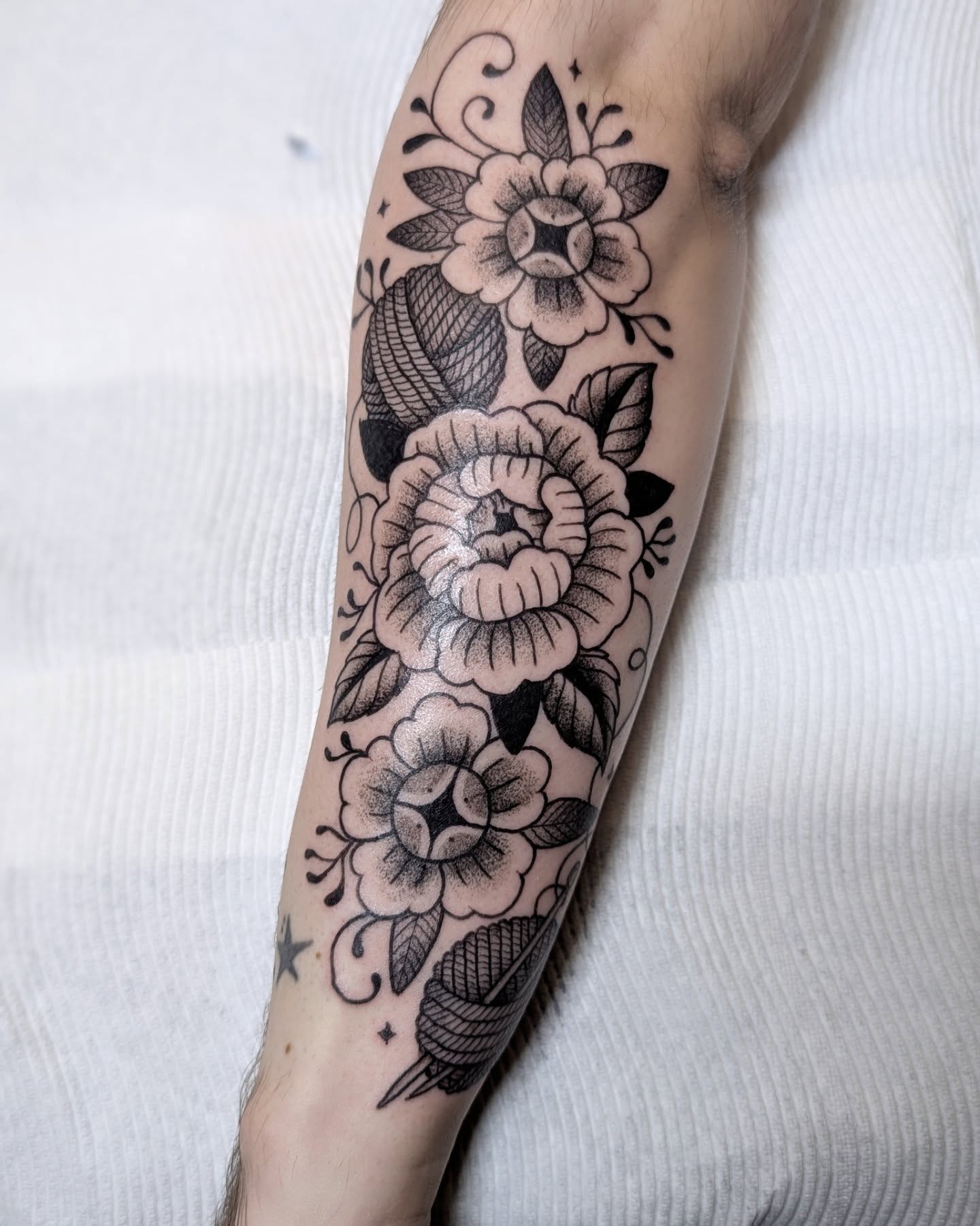 Floral bouquet black and grey tattoo on the forearm by Dani Harkey