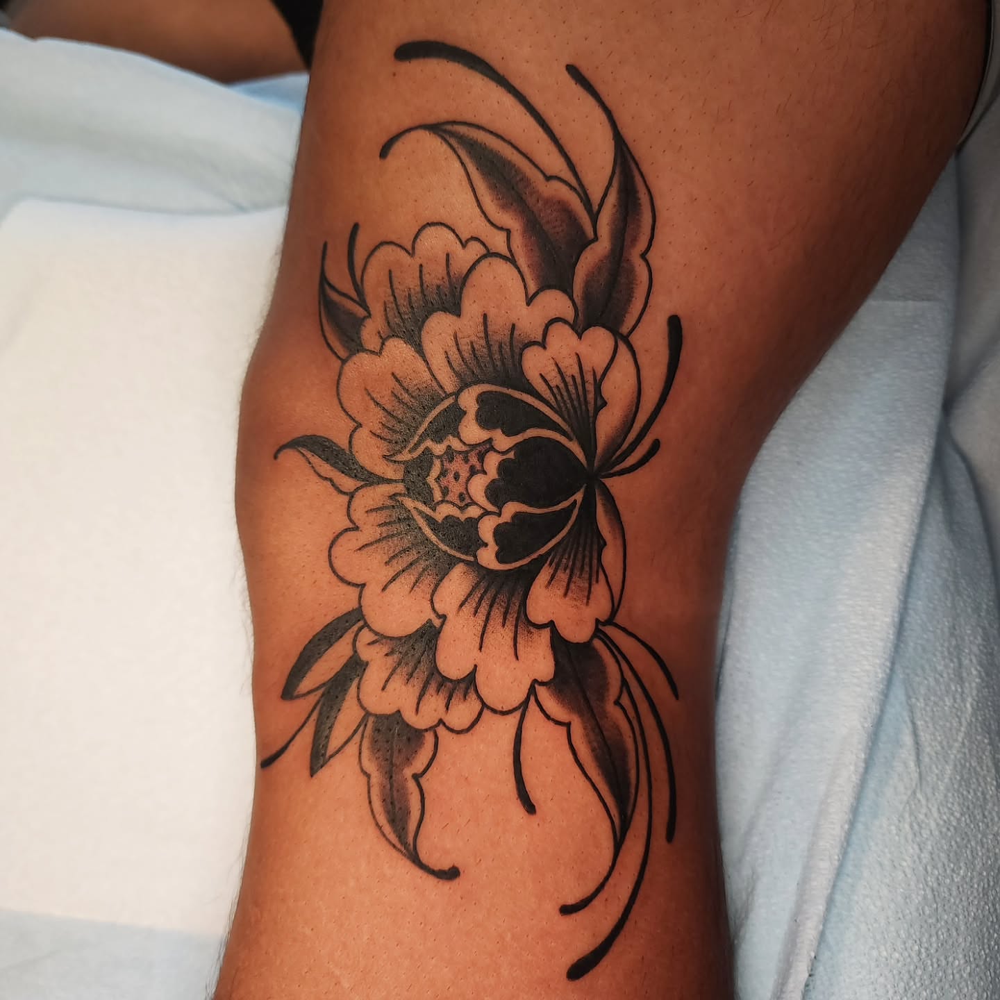 Peony flower black and grey tattoo on the forearm by Maxine Stewart
