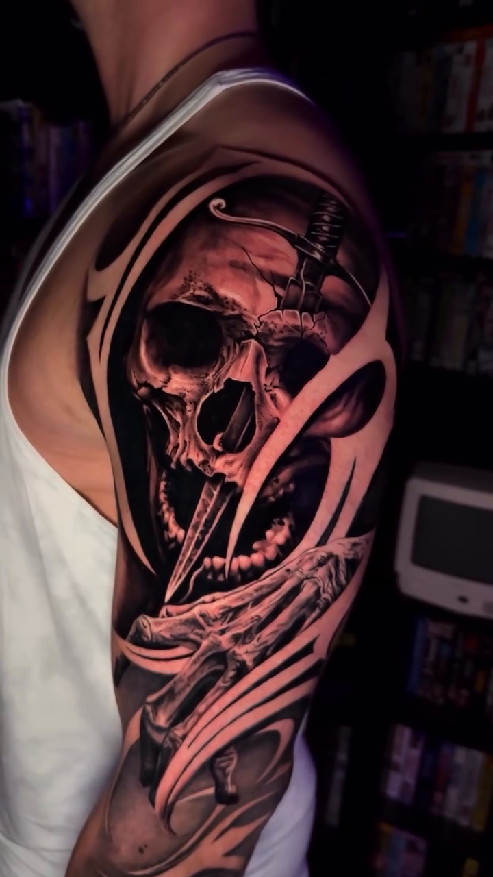 Skull with mechanical elements realism tattoo on the upper arm by Tommy Nguyen, Eastpointe, Michigan