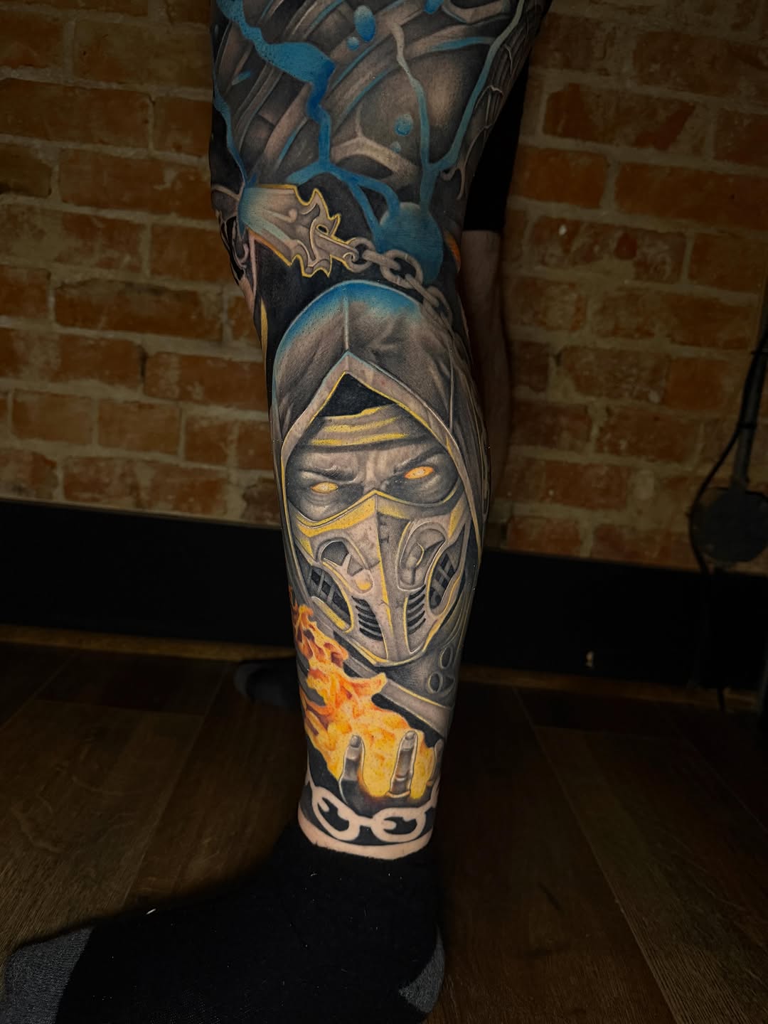 Scorpion from Mortal Kombat surrealism tattoo on the leg by Taylor Steckman