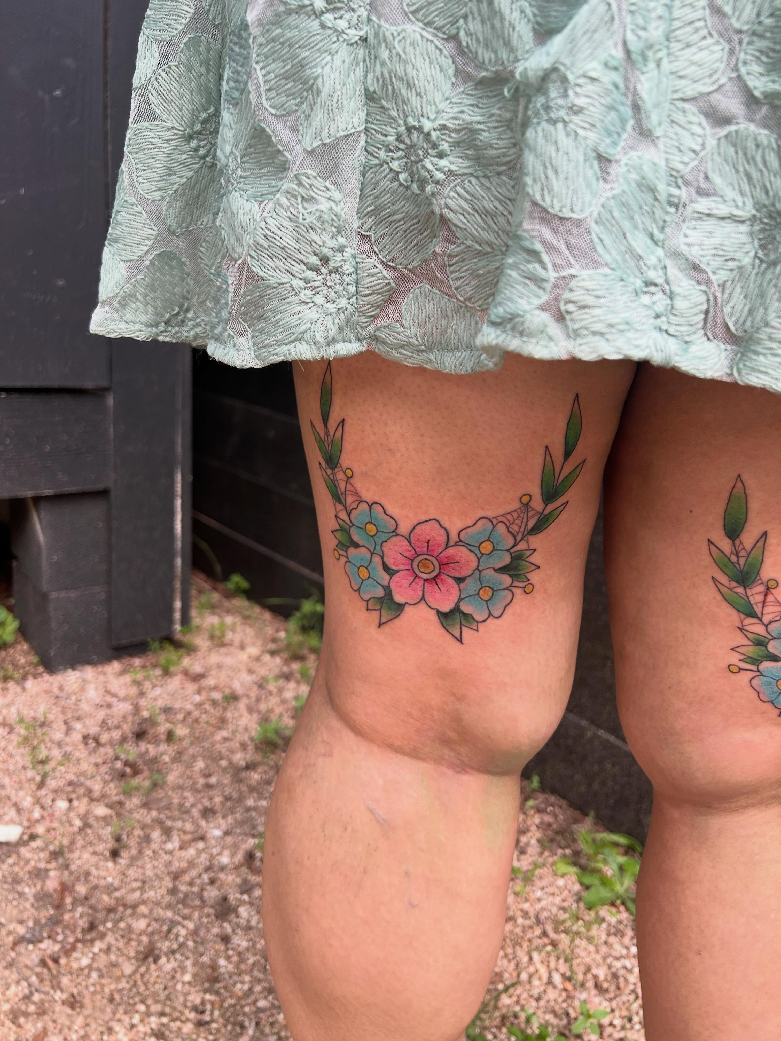 Floral wreath dotwork tattoo on the thigh by Miss Katie