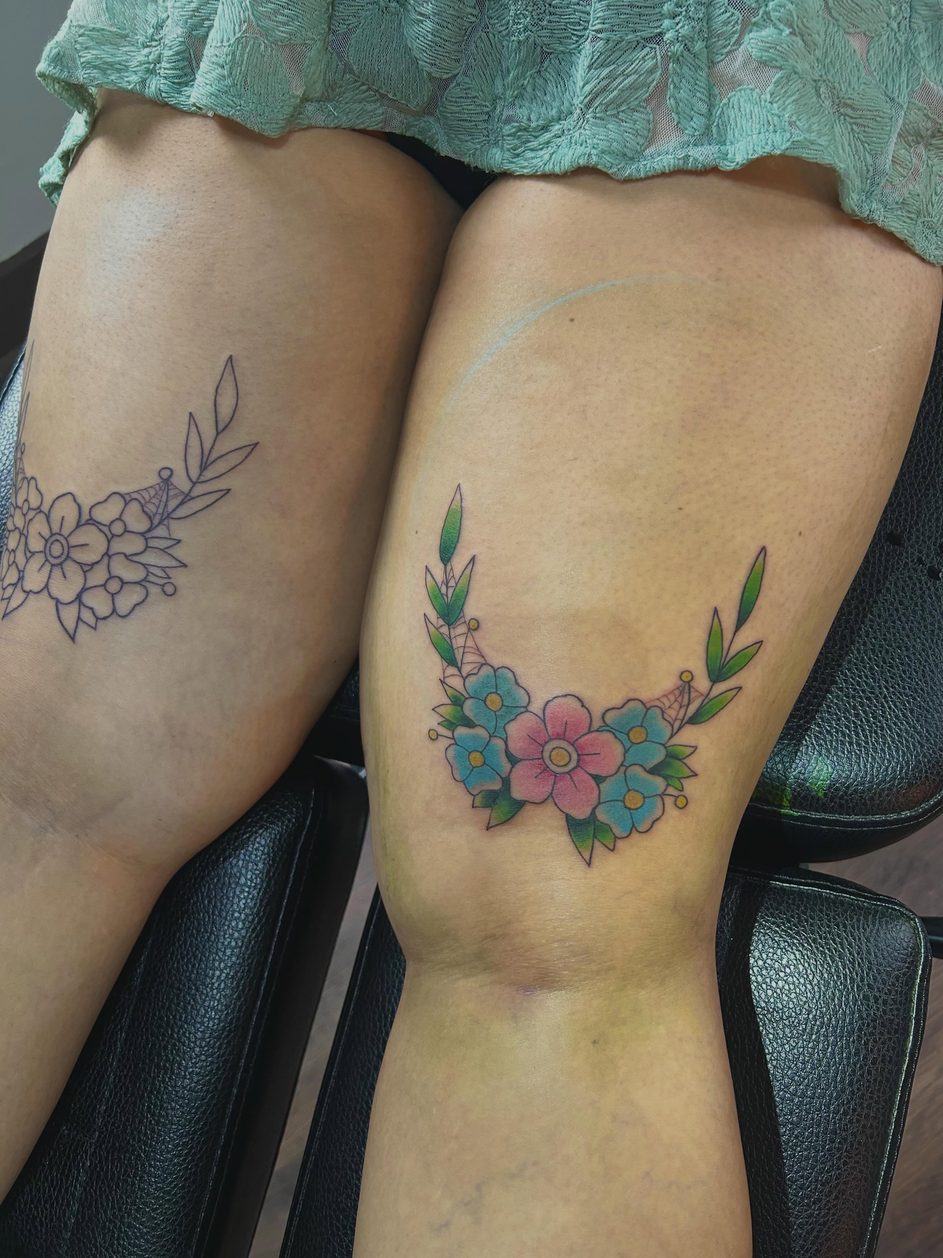 Floral wreath new school tattoo on the thigh by Miss Katie