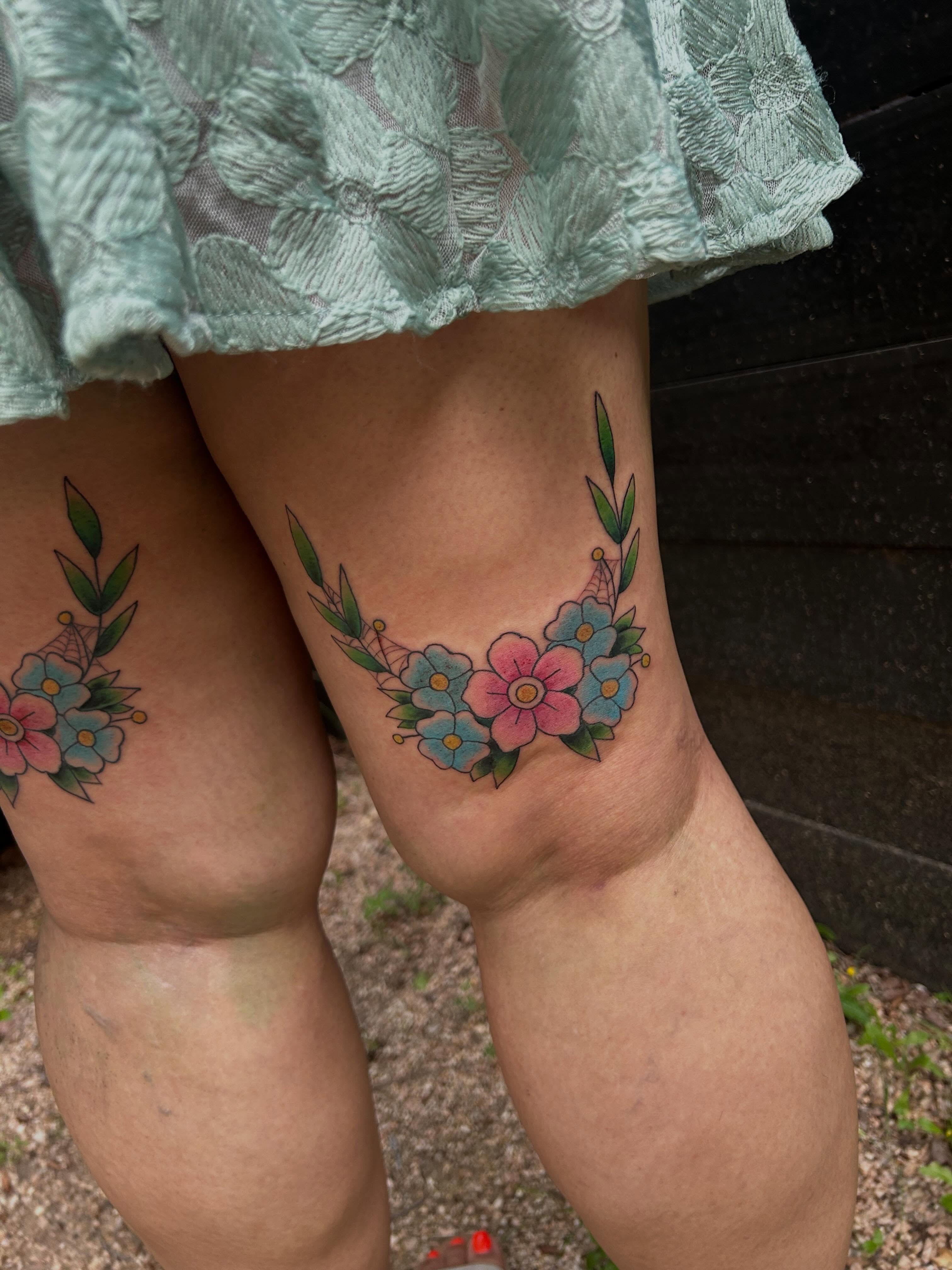 Floral wreath American traditional tattoo on the thigh by Miss Katie