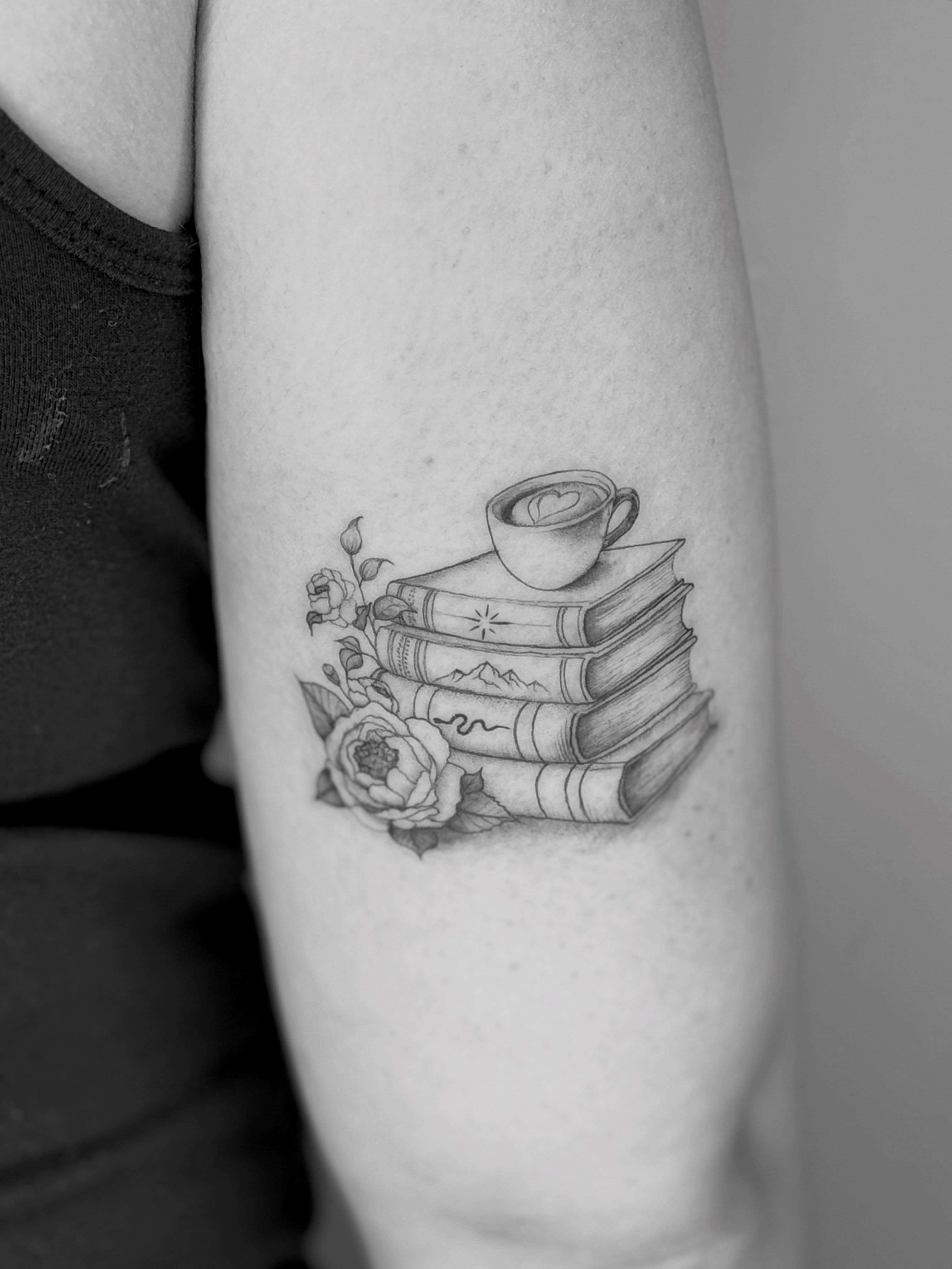 Books and coffee cup realism tattoo on the forearm by Ashley Limon