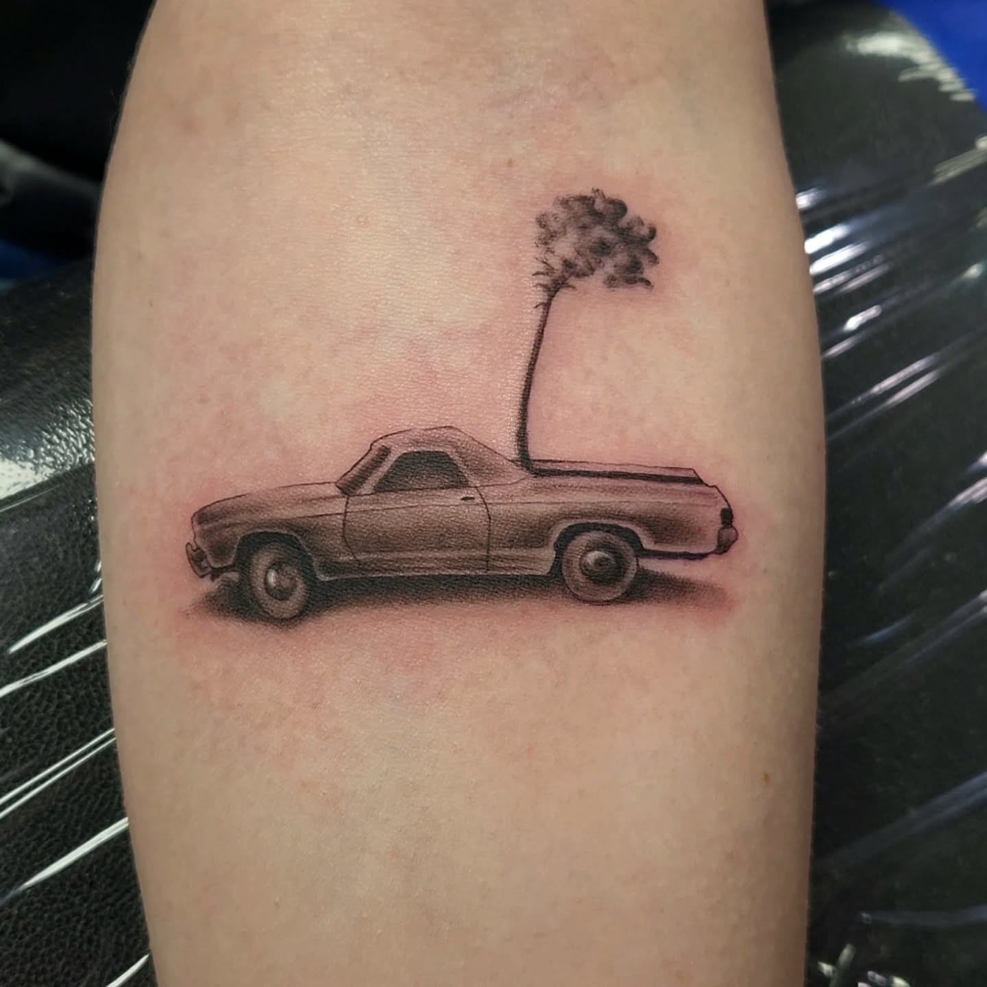 Truck with tree black and grey tattoo on the forearm by Jason August
