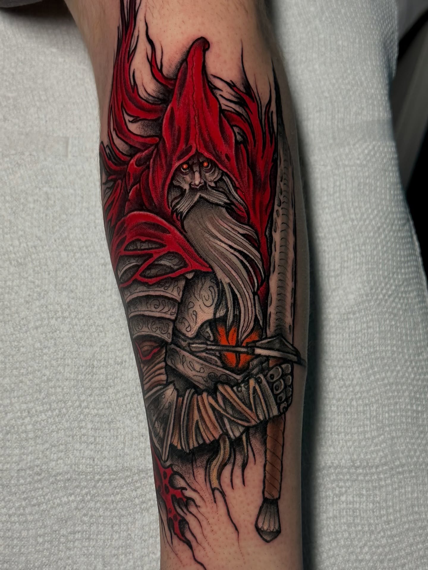 Red-robed warrior realism tattoo on the forearm by 𝐀𝐮𝐬𝐭𝐢𝐧 𝐌𝐨𝐫𝐫𝐢𝐬𝐨𝐧 𝐓𝐚𝐭𝐭𝐨𝐨𝐬
