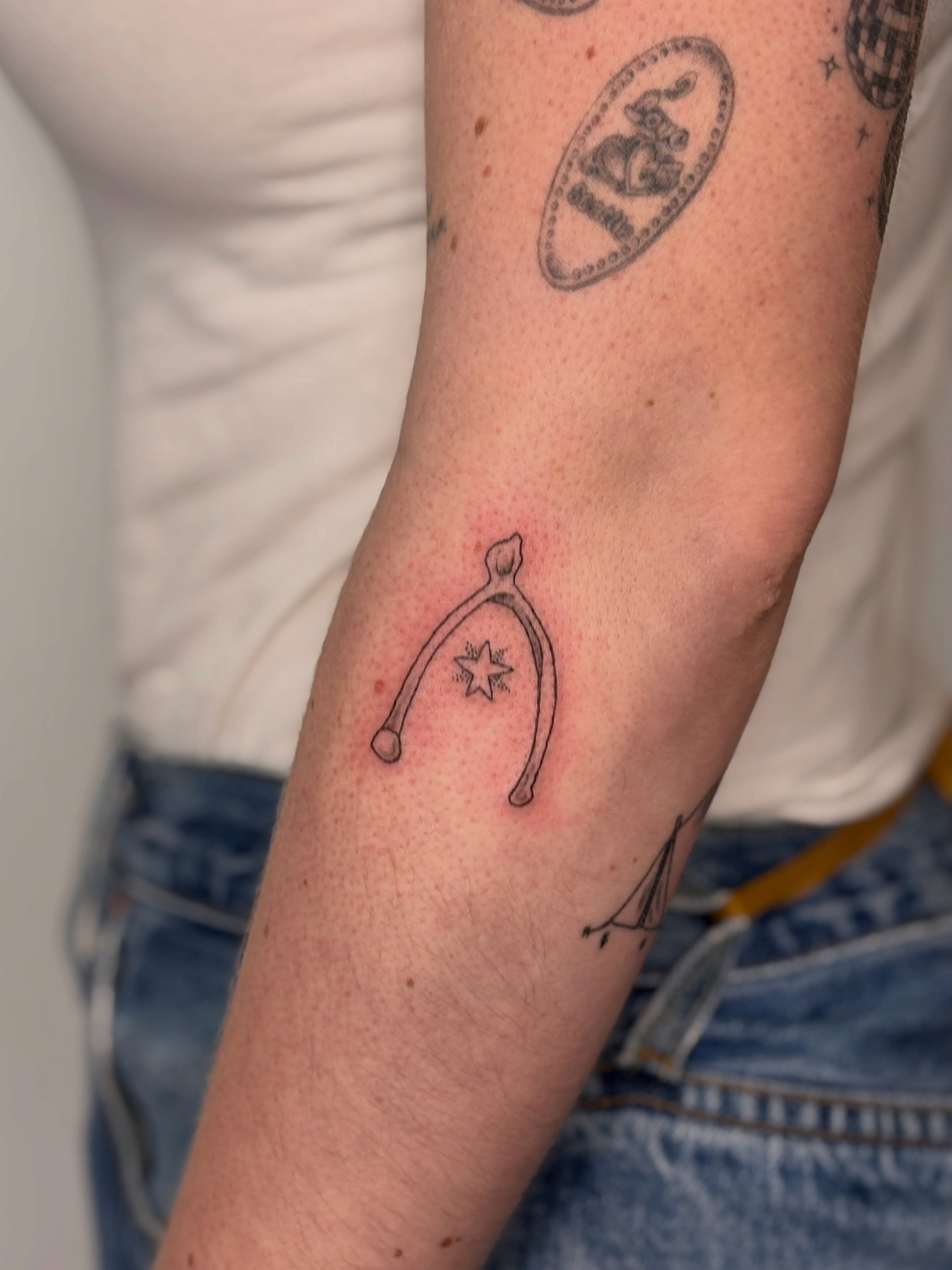 Wishing stick black and grey tattoo on the forearm by Maddie