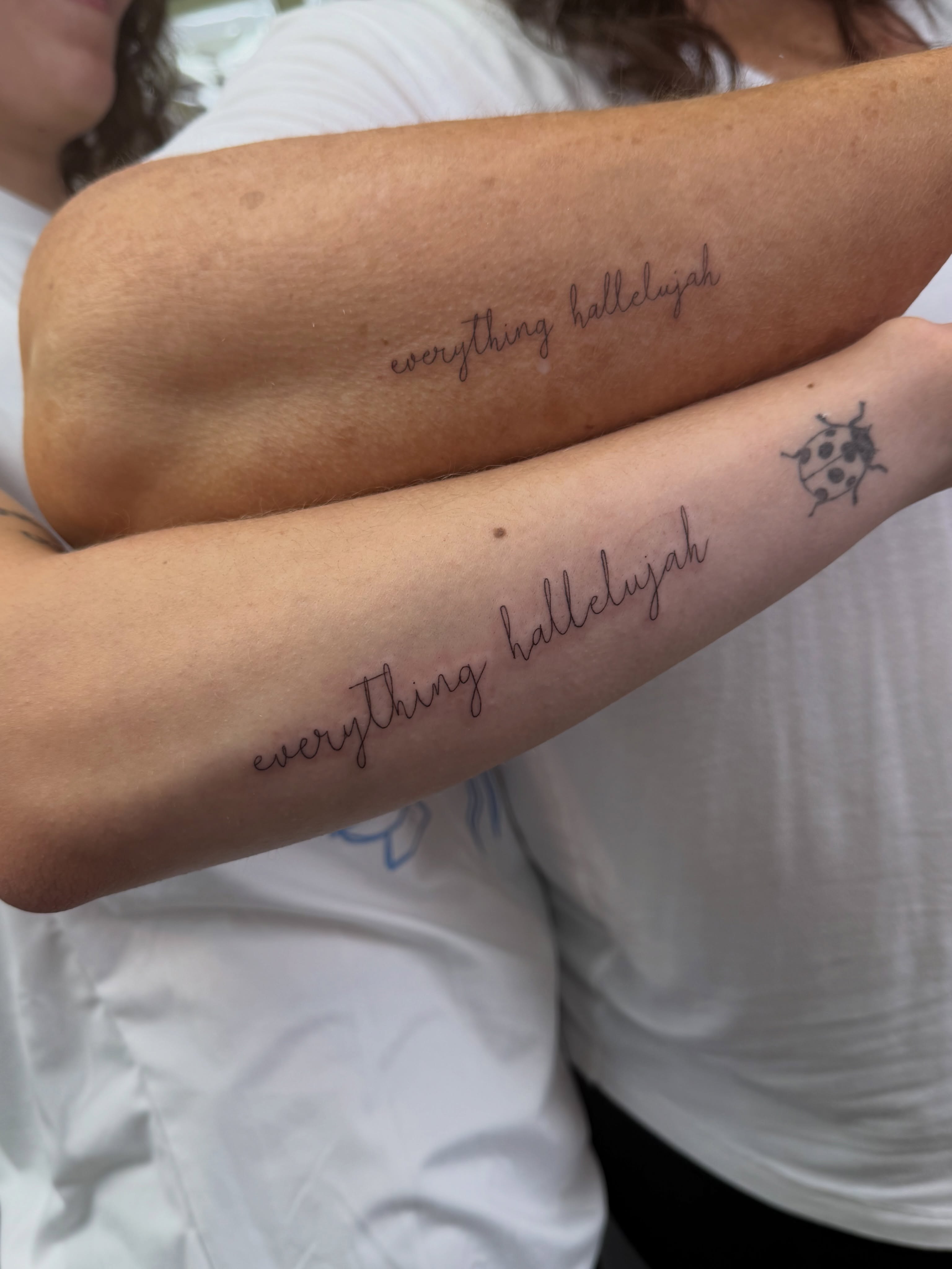 Everything hallelujah lettering script tattoo on the forearm by Henesee Parfitt