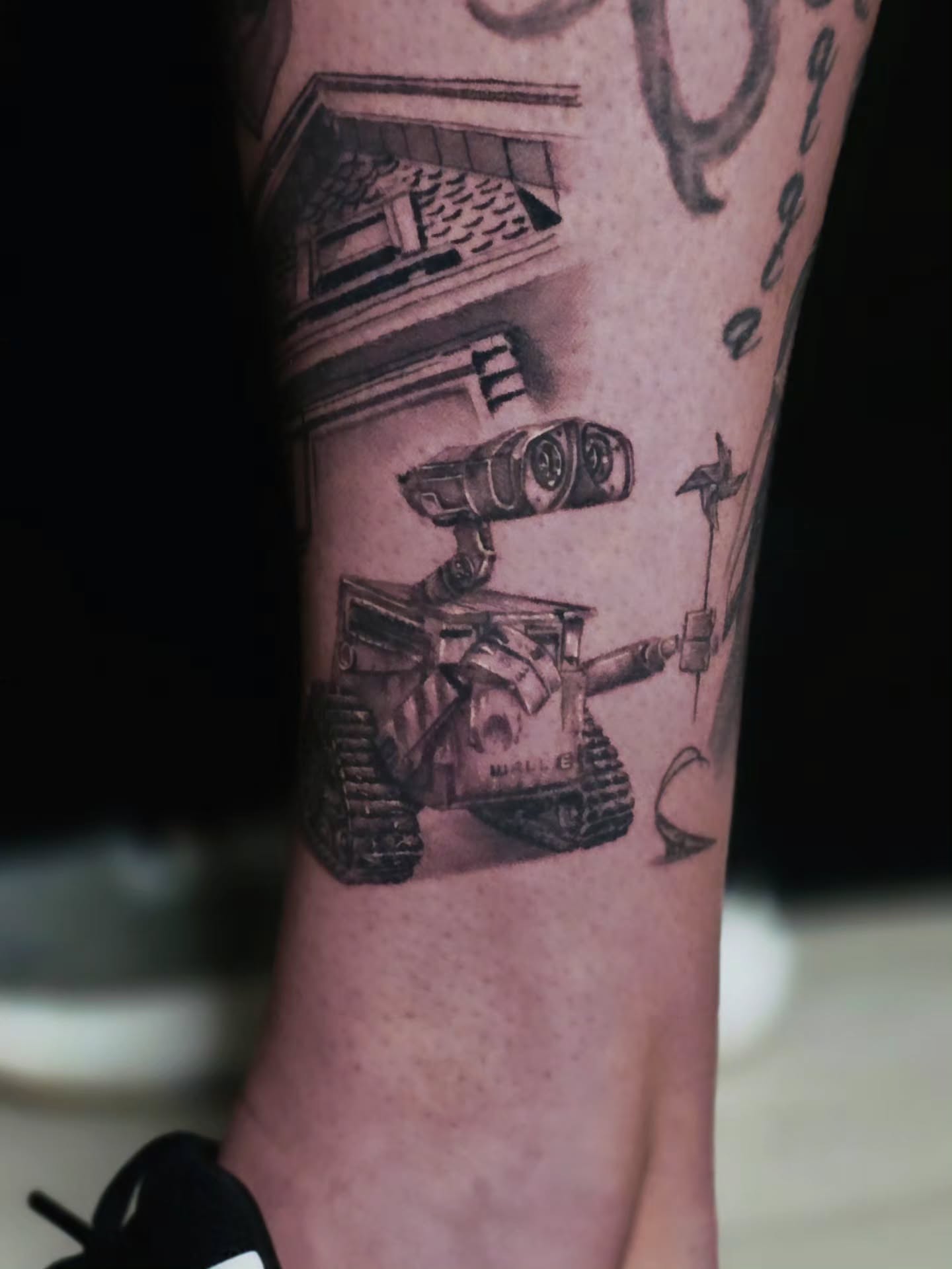 Wall-e robot realism tattoo on the forearm by Jake Barney