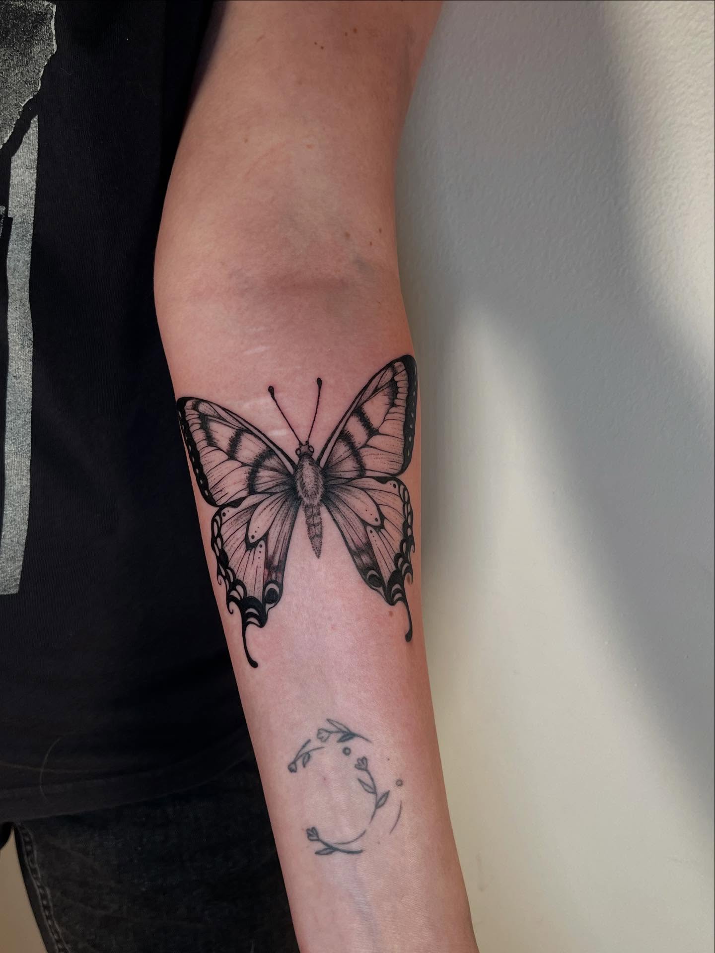 Butterfly black and grey tattoo on the forearm by Elisa