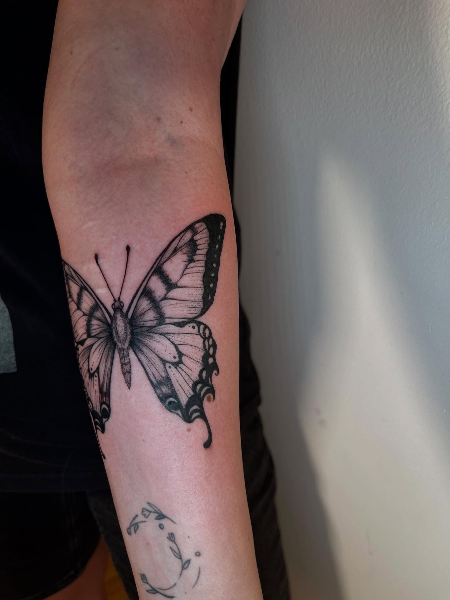 Butterfly black and grey tattoo on the forearm by Elisa