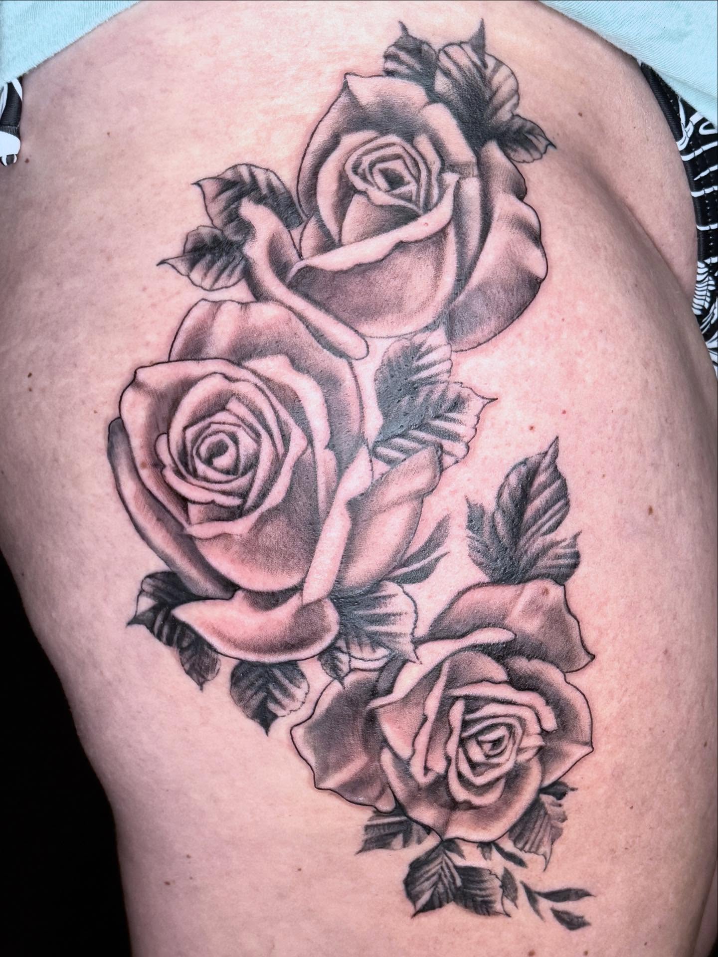 Roses black and grey tattoo on the thigh by Cody Glenn