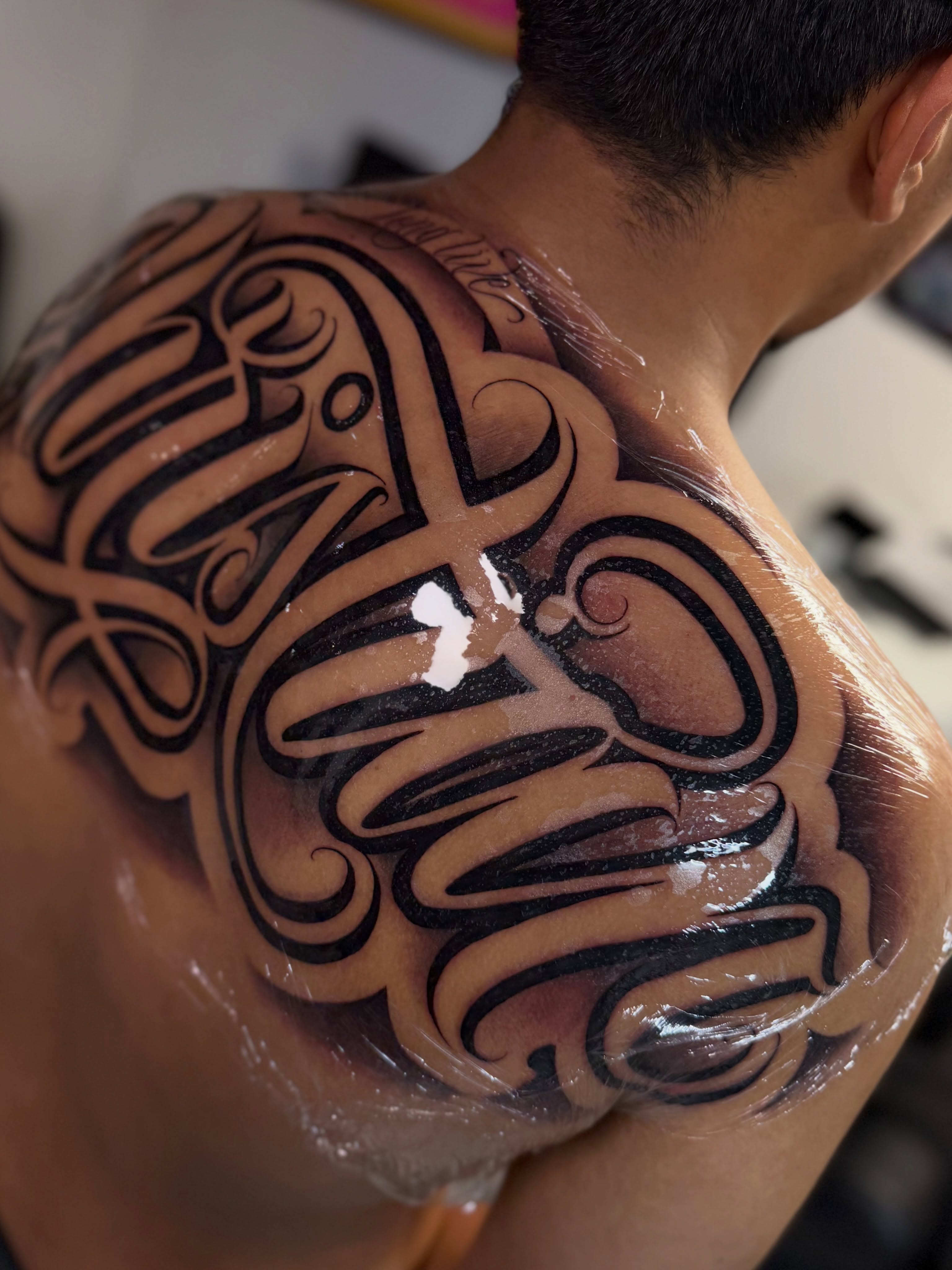 Script lettering lettering script tattoo on the shoulder by Rocky G Inkz LLC