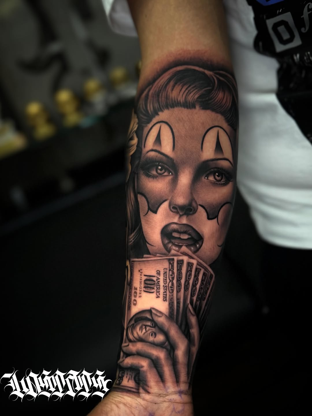 Woman with clown makeup and money Chicano tattoo on the forearm by LOS