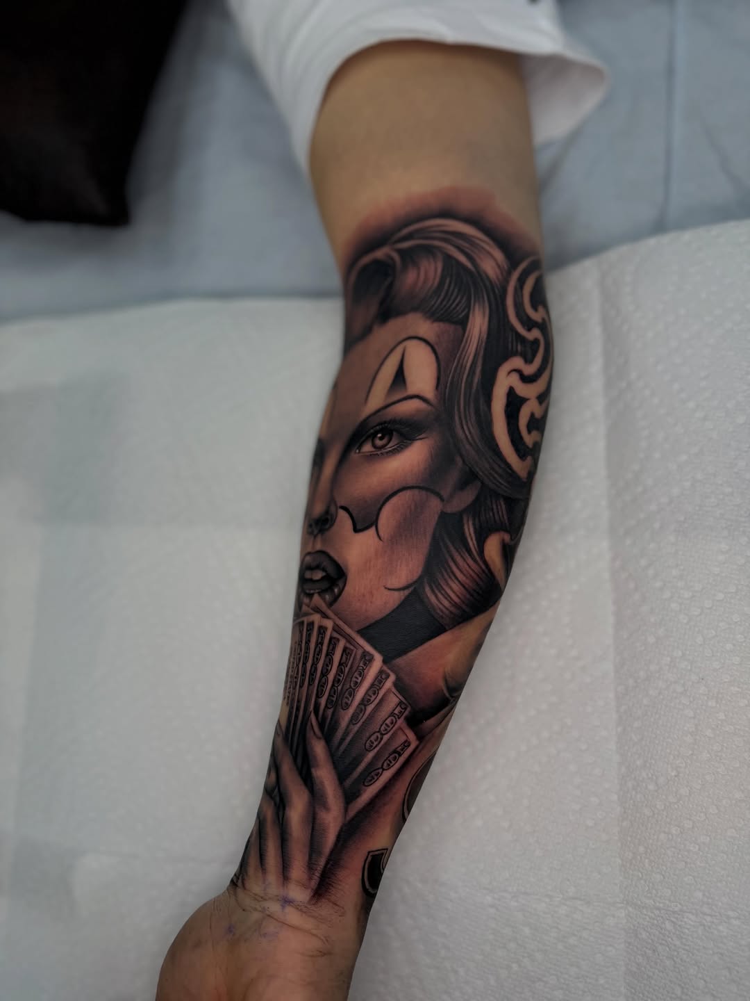 Woman with money Chicano tattoo on the forearm by LOS