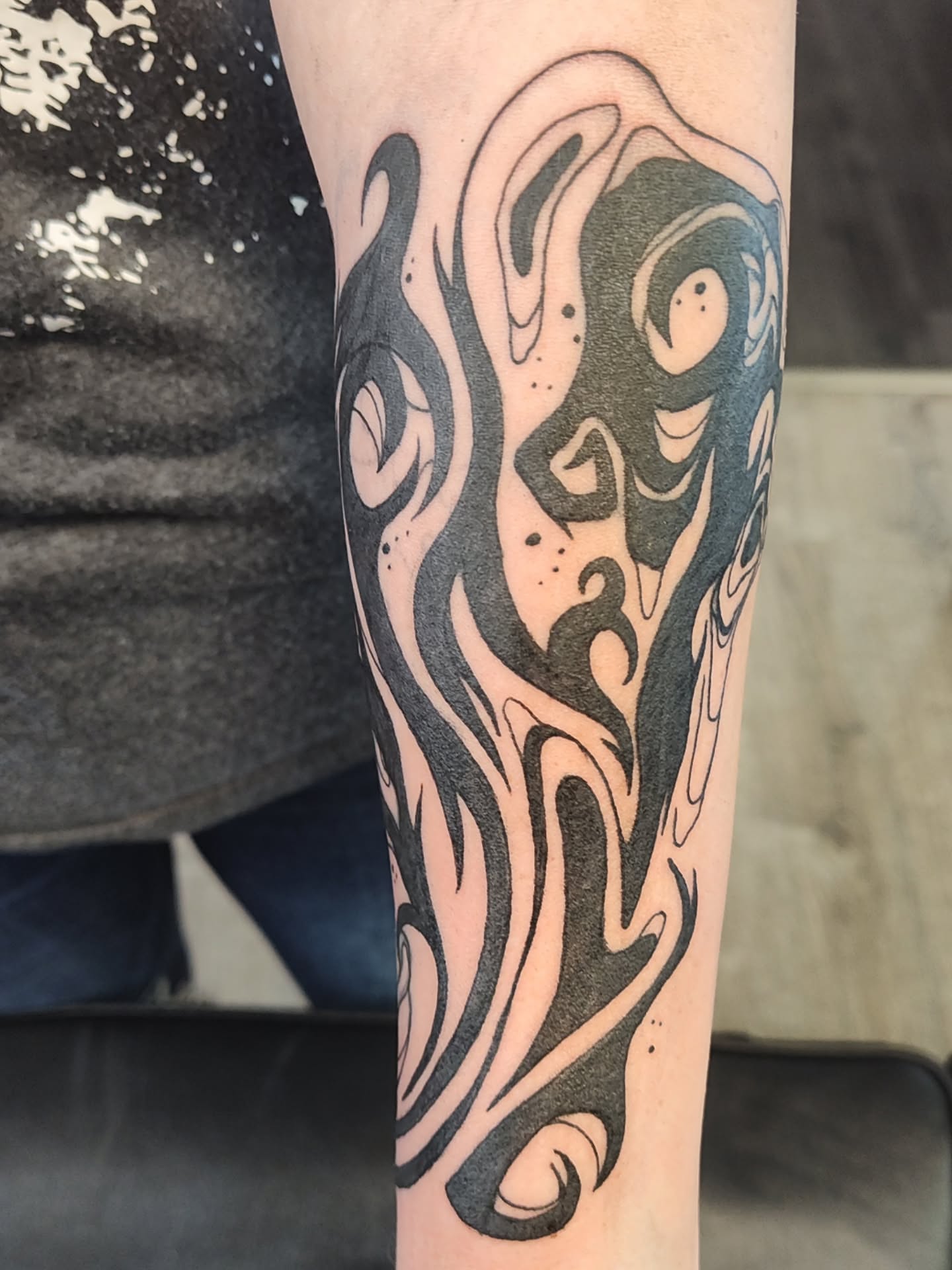 Abstract flame black and grey tattoo on the forearm by Mercury