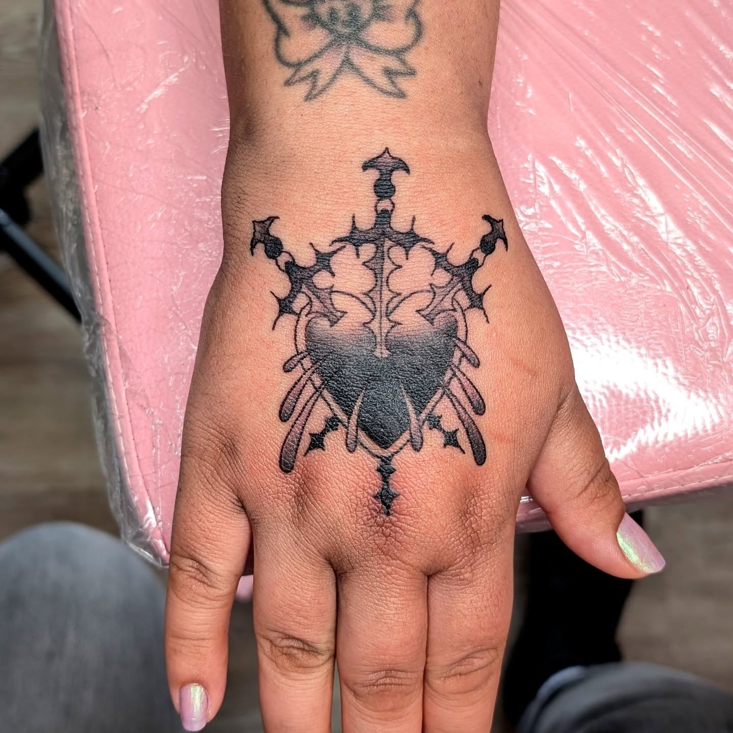 Cross with thorns black and grey tattoo on the hand by norn noszka