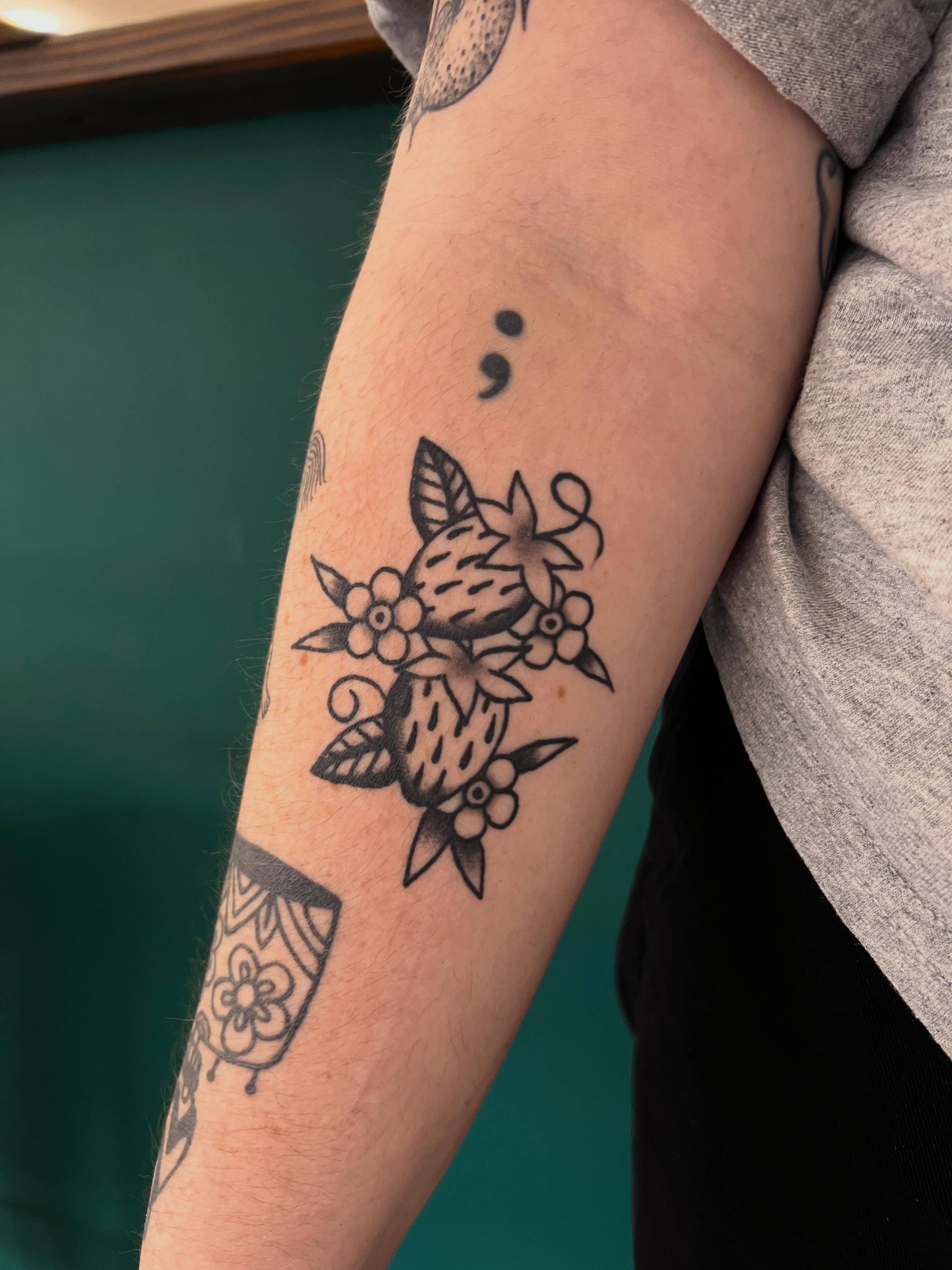 Fruit and flowers black and grey tattoo on the forearm by Samantha Citer