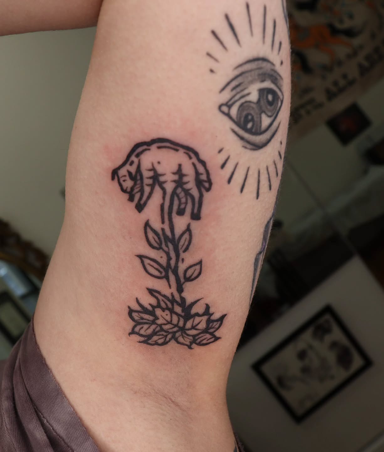 Elephant and flower black and grey tattoo on the forearm by Veronika Lipchak