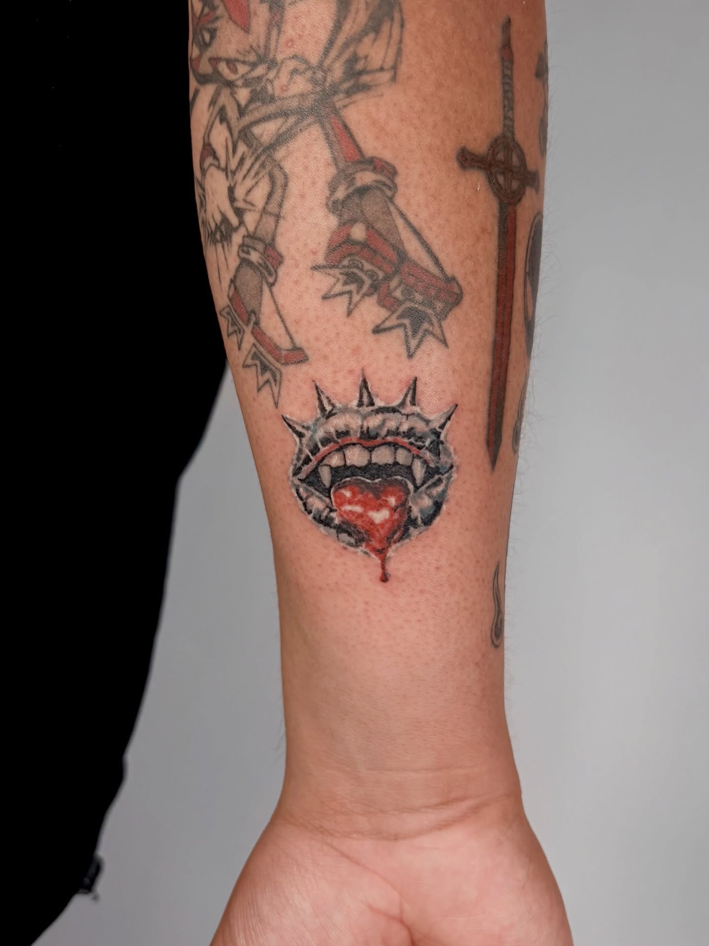 Bleeding mouth with spikes dark realism tattoo on the forearm by Rami, Maden🇰🇷